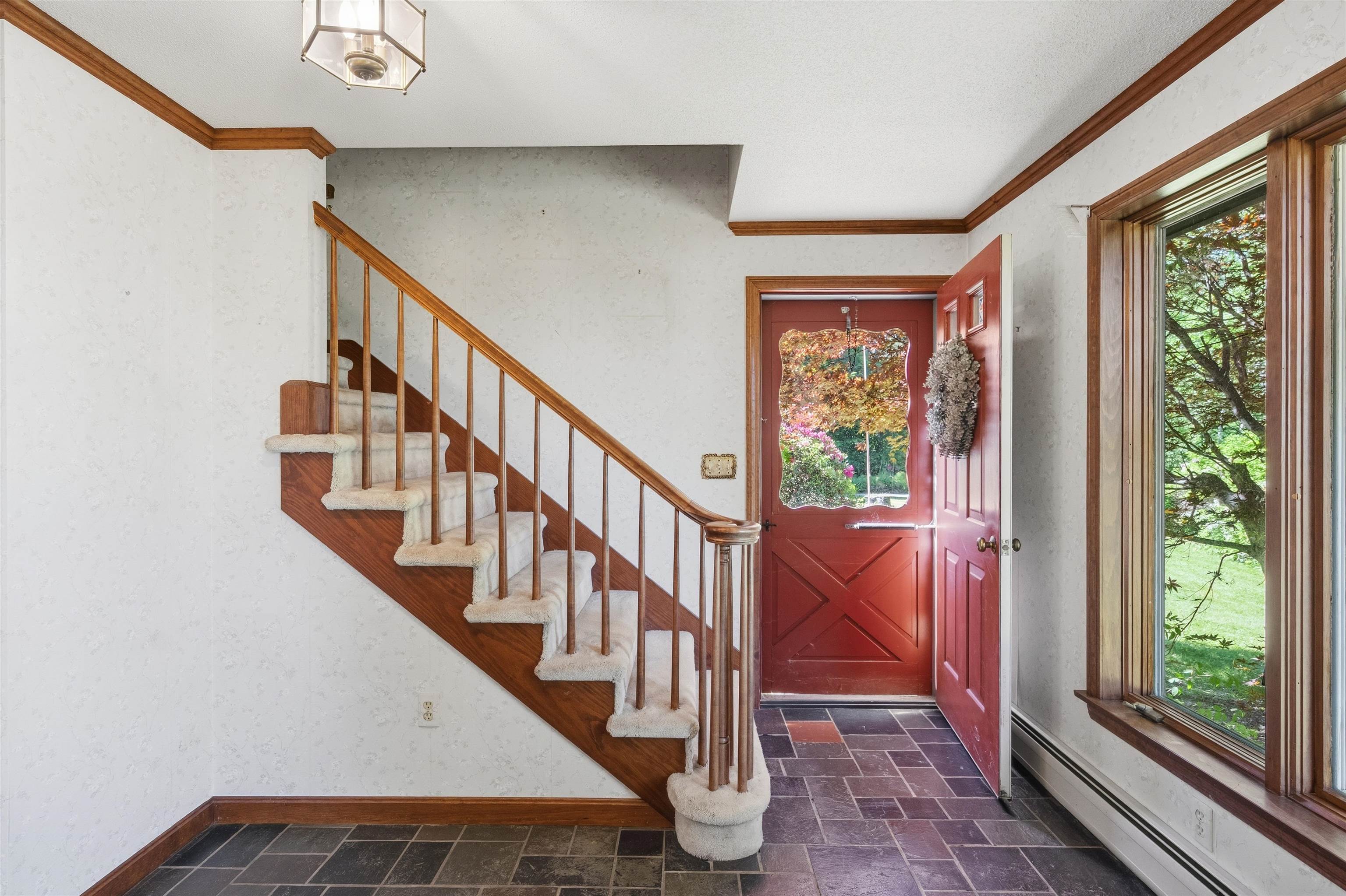 Foyer with slate floor and picture window 25498050