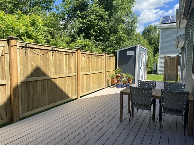 Spacious back deck with shed 25636372
