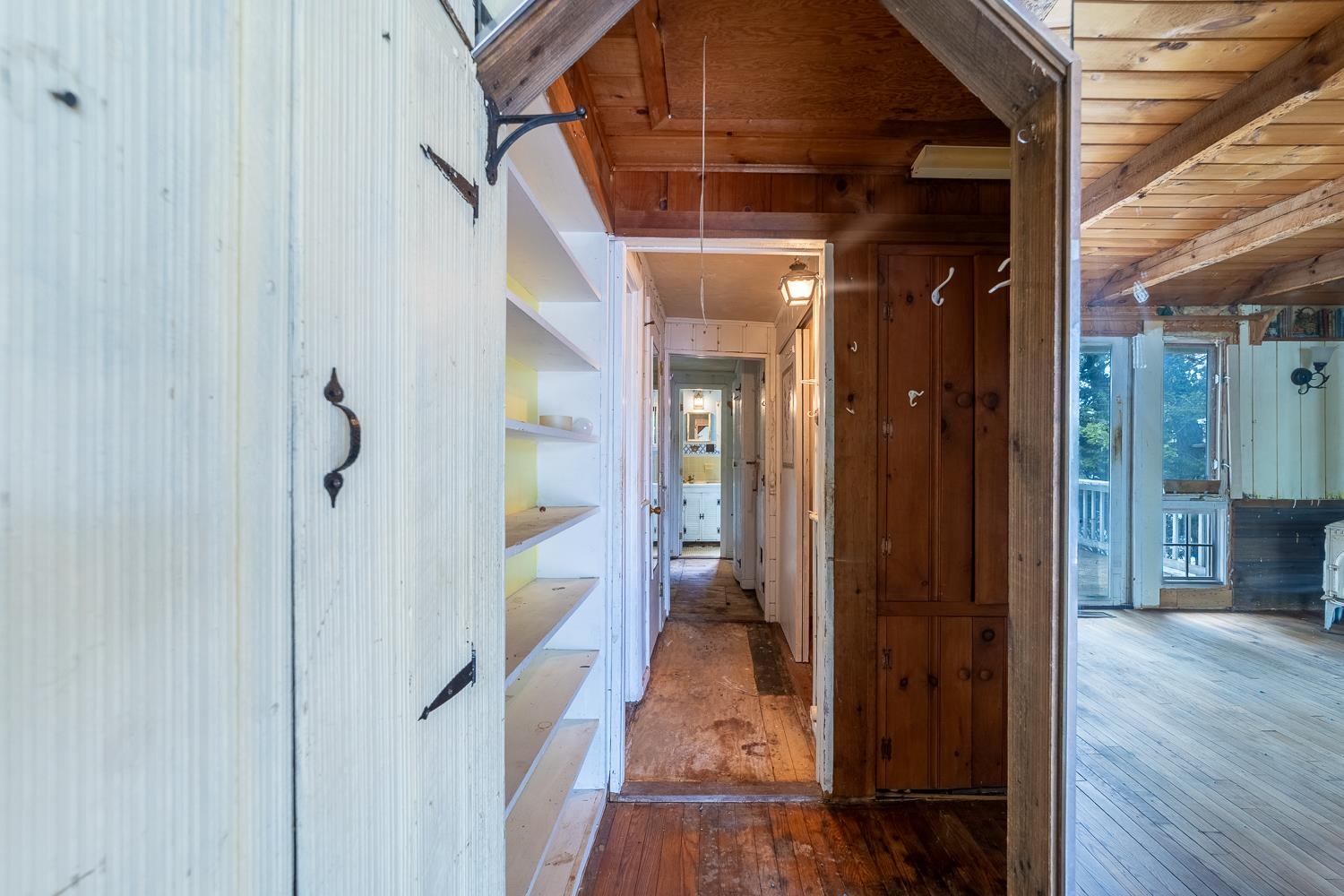The hallway offers access to two bedrooms and two bathrooms. 25647723