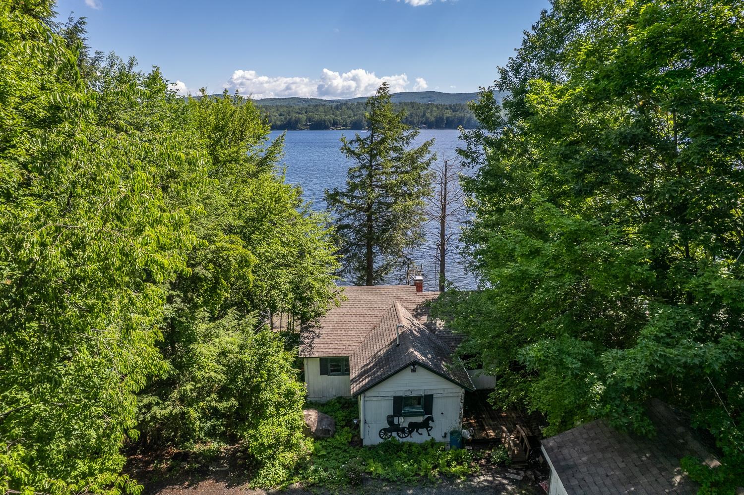 Mature trees border the property, offering natural seclusion. 25647745