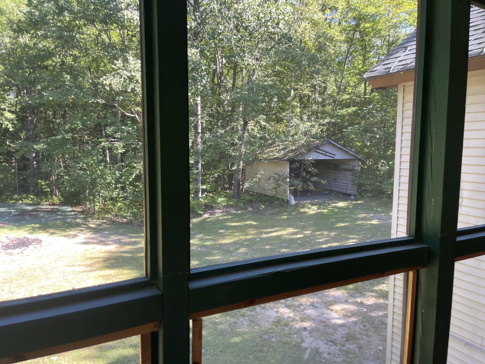 BEHIND THE HOUSE IS AN OPEN GARAGE PERFECT FOR A BOAT OR LARGE TRUCK STORAGE