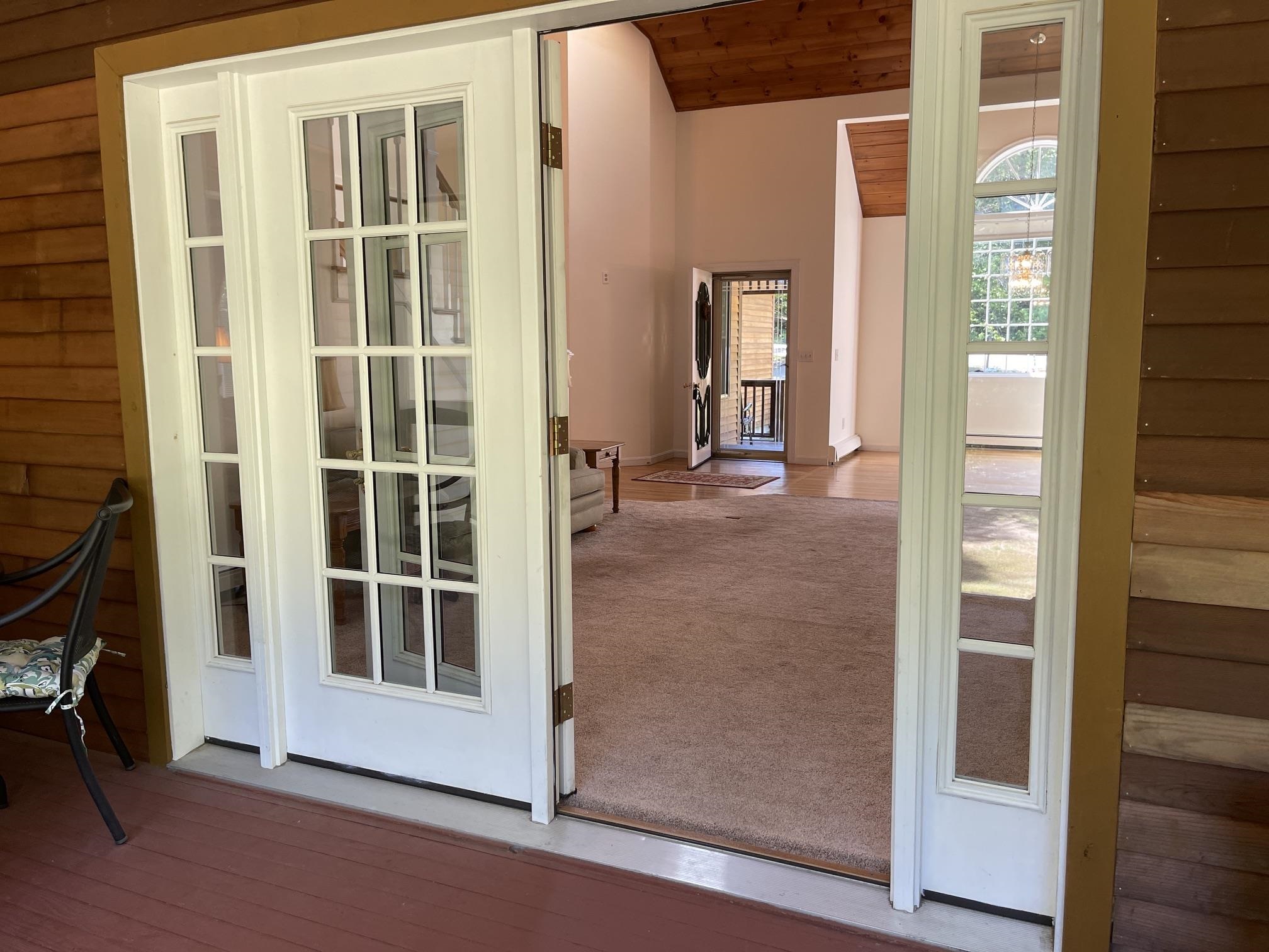 FROM THE PORCH YOU CAN LOOK INTO THE LIVING ROOM TO THE FRONT DOOR.