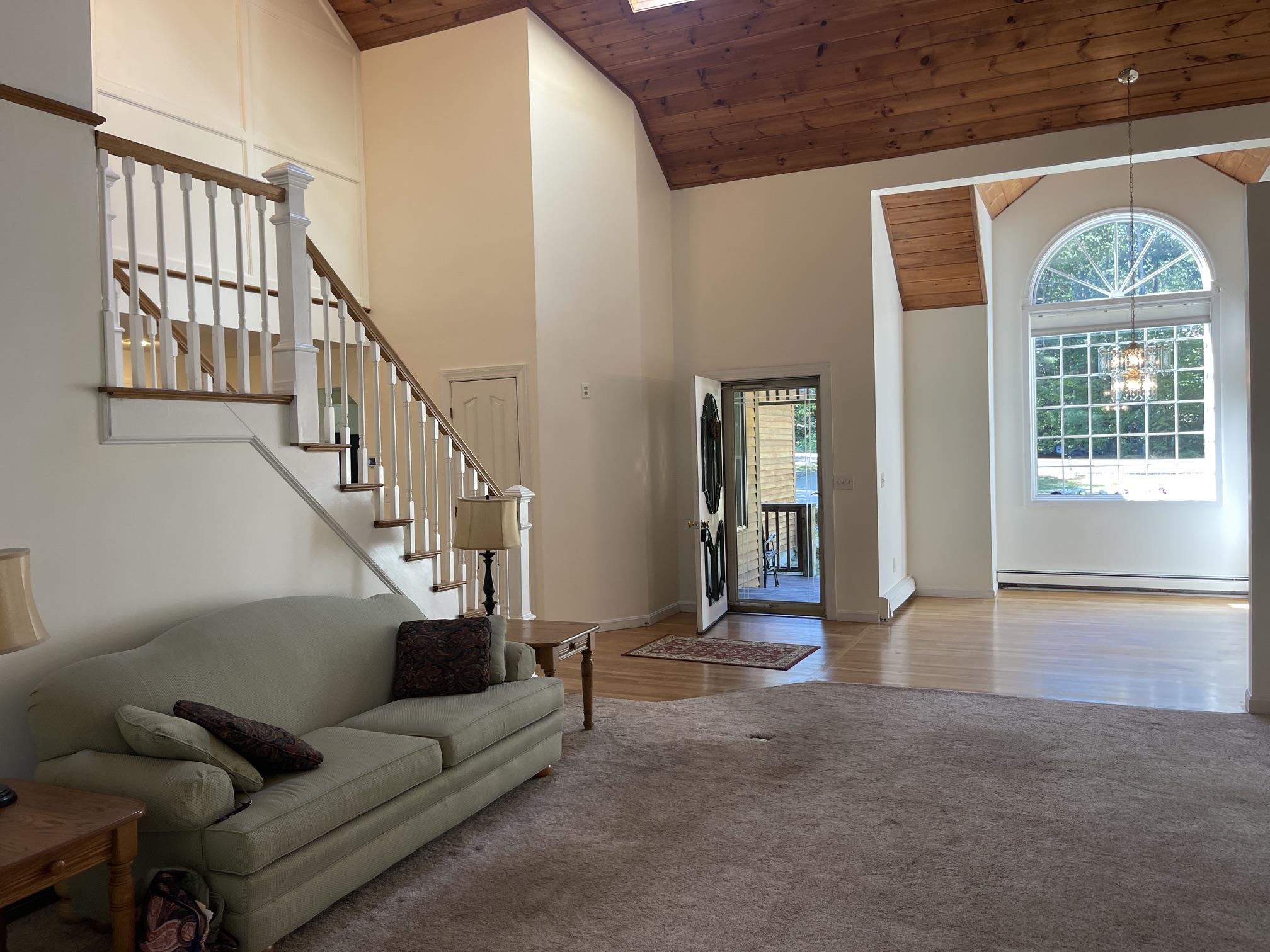 YOU ARE GREETED WITH WOOD VAULTED CEILINGS AND A GORGEOUS STAIRWELL!!