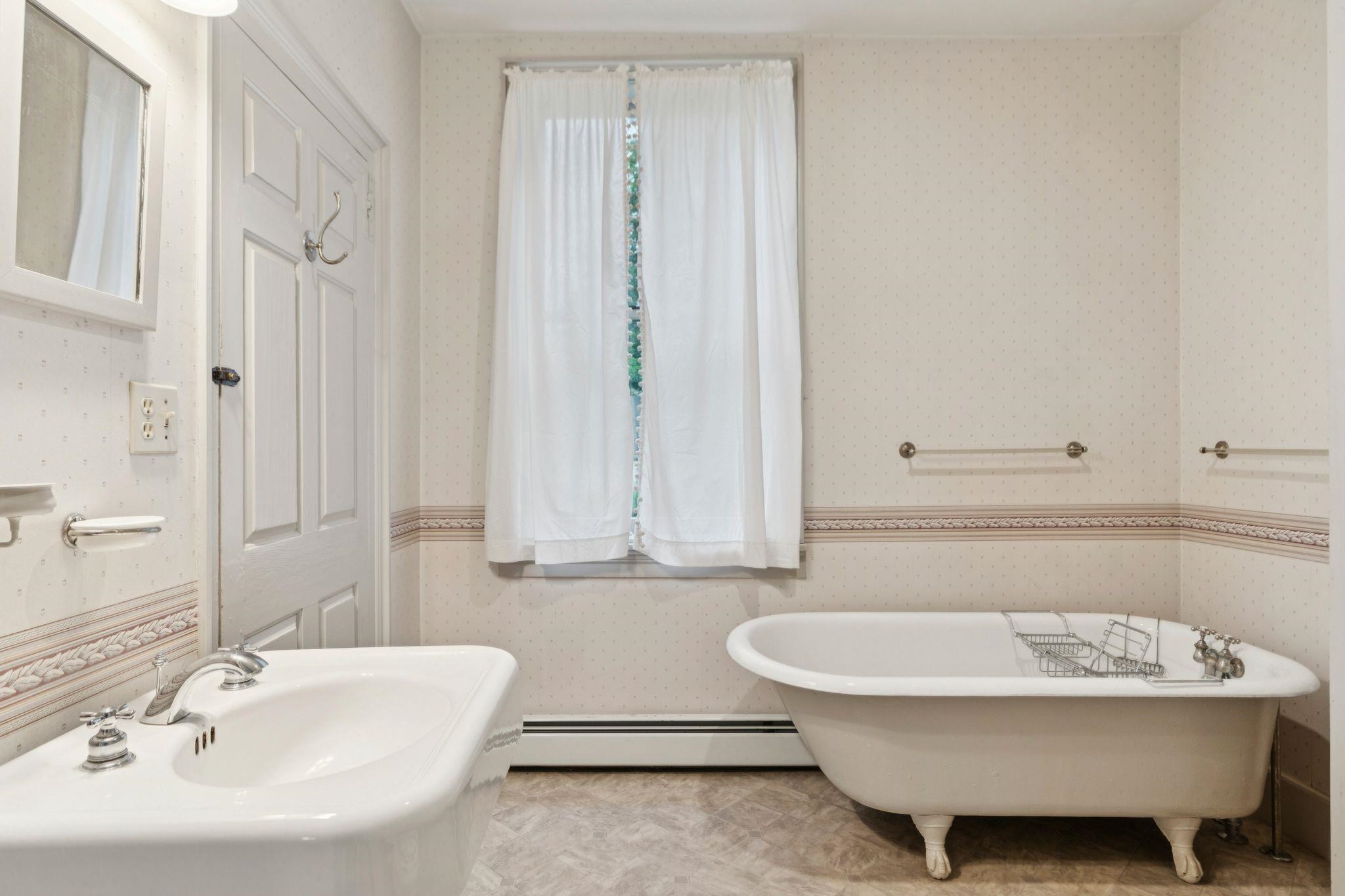 Unstaged 1st floor full bath w laundry hookups