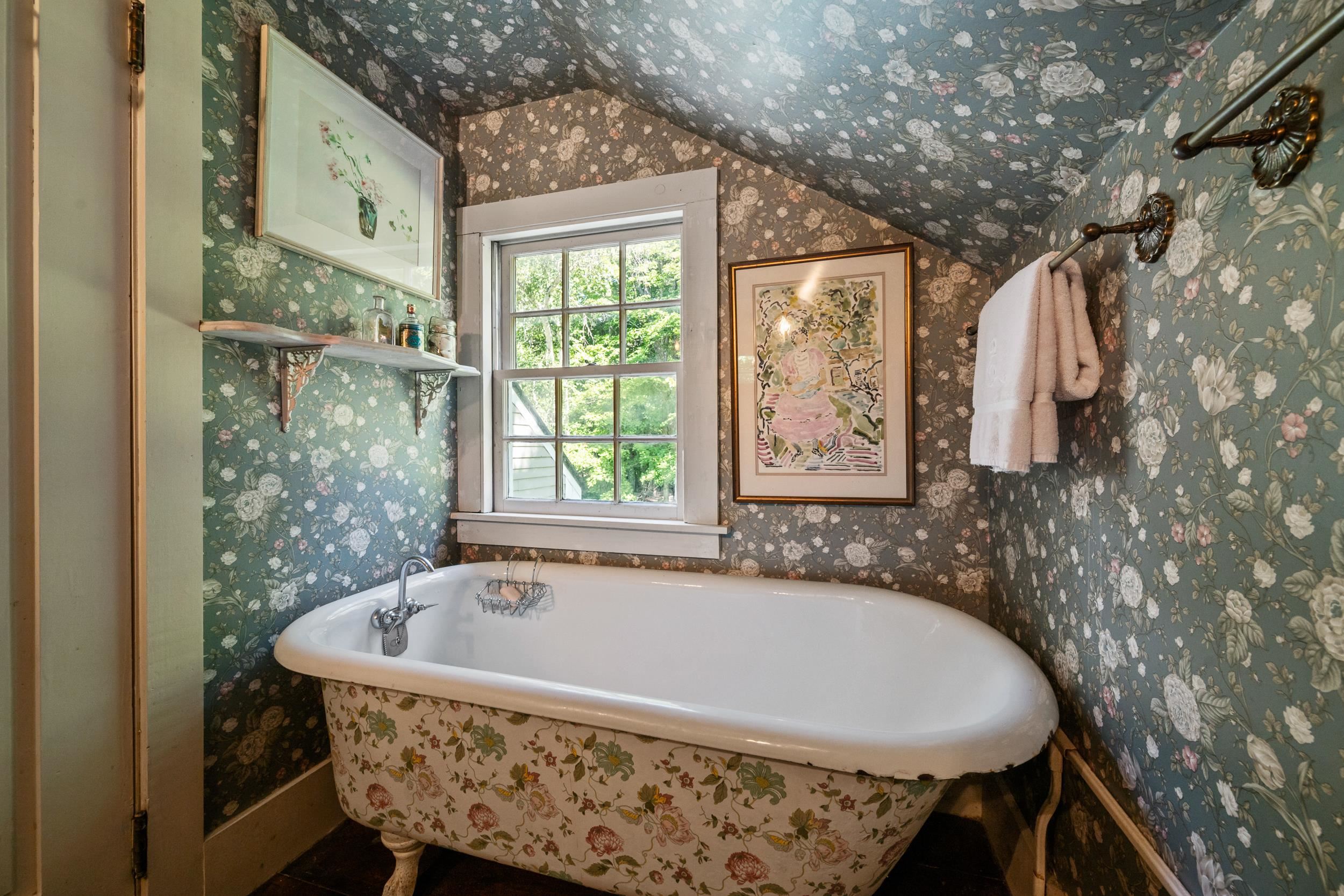 A CLAW FOOT TUB COMPLETES THIS BATHROOM.