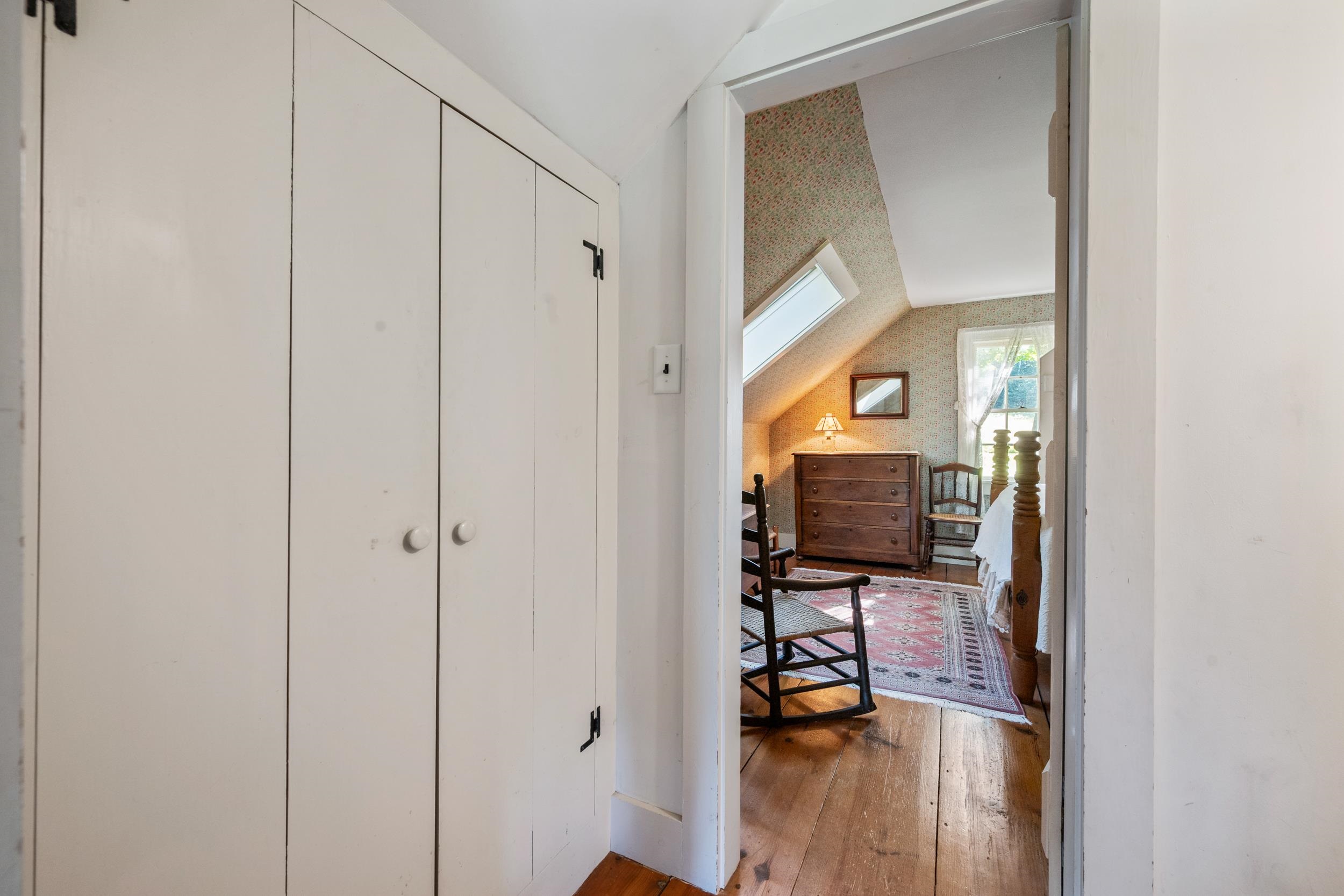 THE HALLWAY AT THE TOP OF THE FRONT STAIRS WITH MORE CLOSETS.