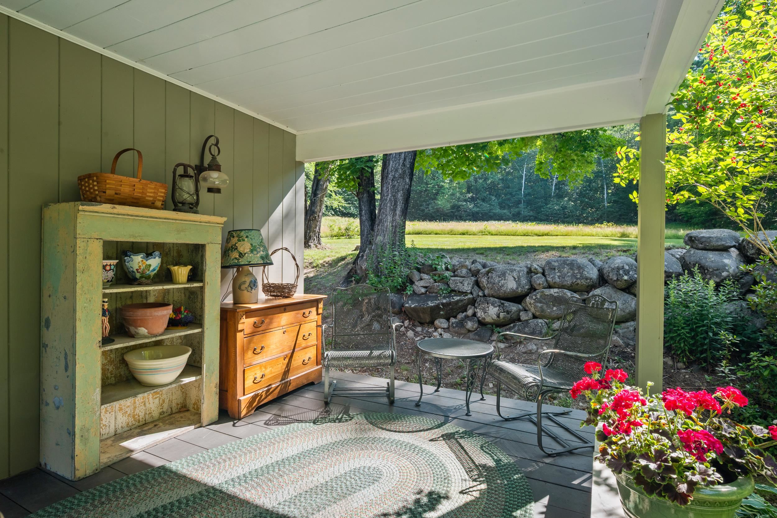 OFF THE SIDE LIVING AREA IS ACCESS TO A SPECIAL OPEN PORCH.