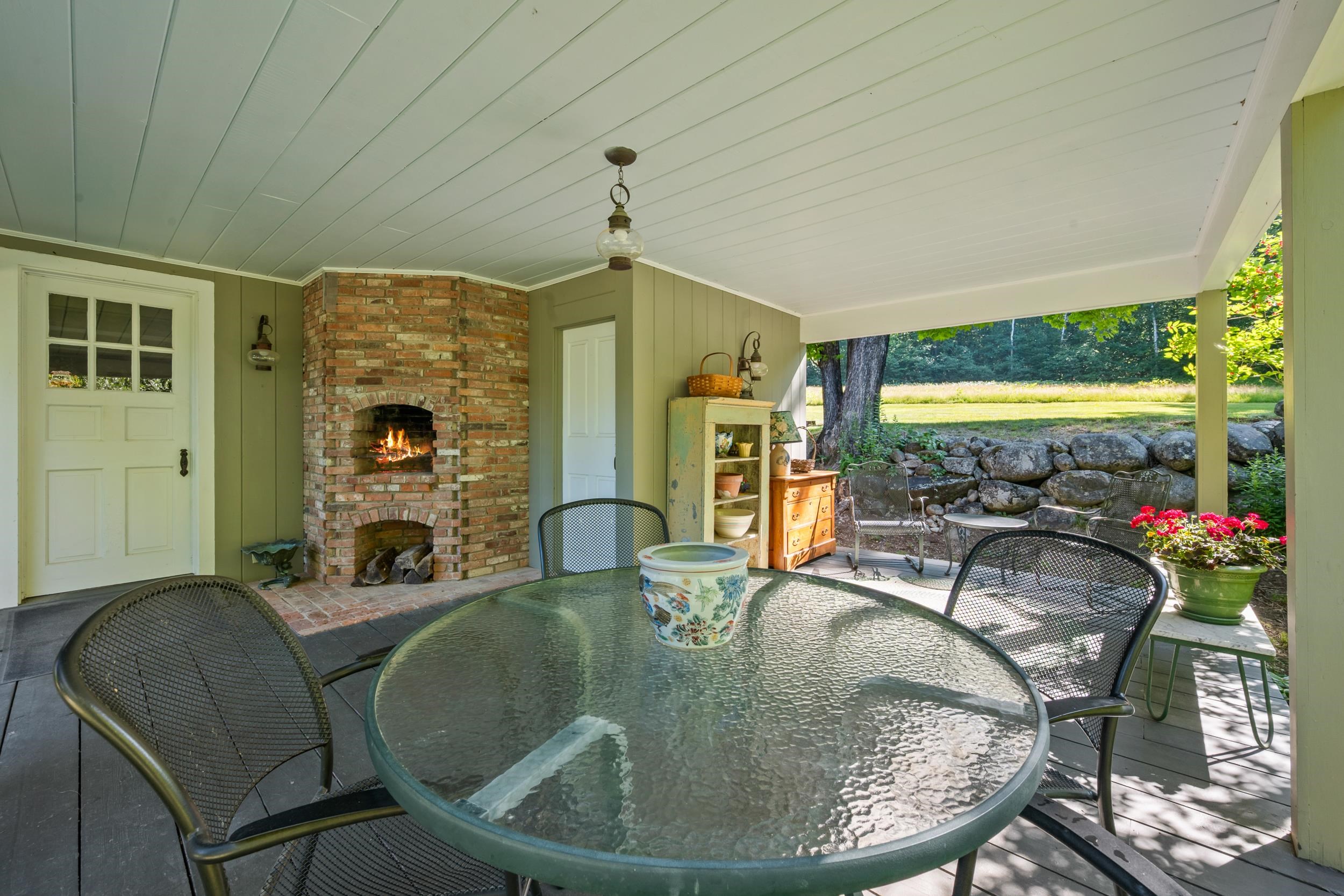 OUTDOOR FIREPLACE OR BUILT IN BARBEQUE GRILL WITH BRICK CHIMNEY HIGHLIGHTS THIS AREA.