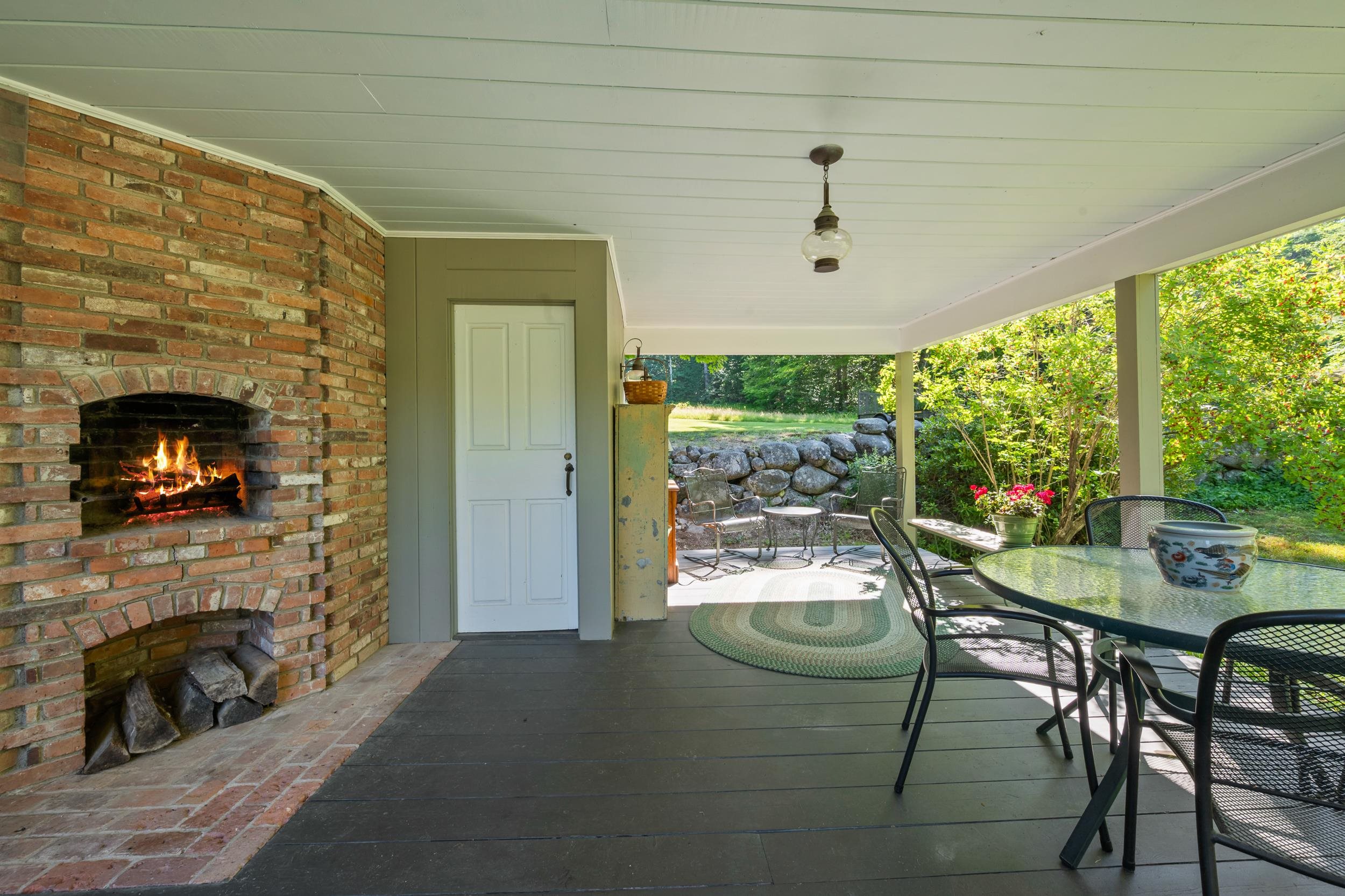 THERE IS A STORAGE SHED OFF THIS PORCH.  THE PORCH LOOKS OVER A STONEWALL IN THE BACK TO THE FIELD.