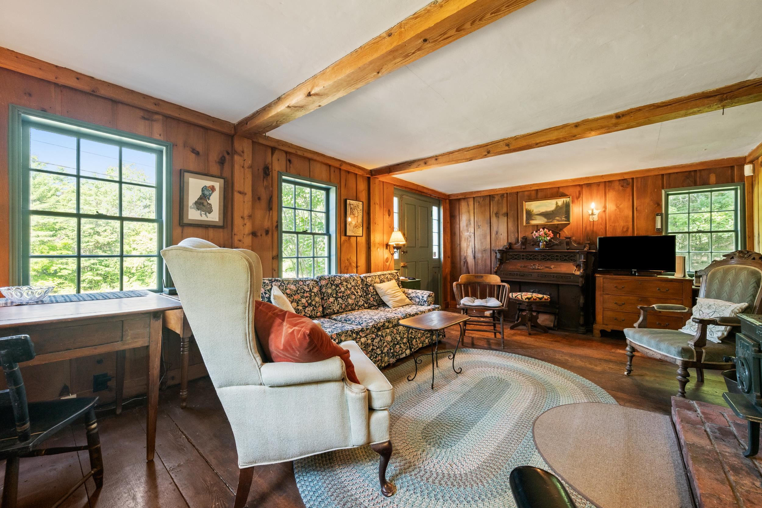 AS YOU ENTER THE FRONT DOOR OF THE HOME, YOU ARE GREETED WITH THE ORIGINAL BEAMED CEILING.