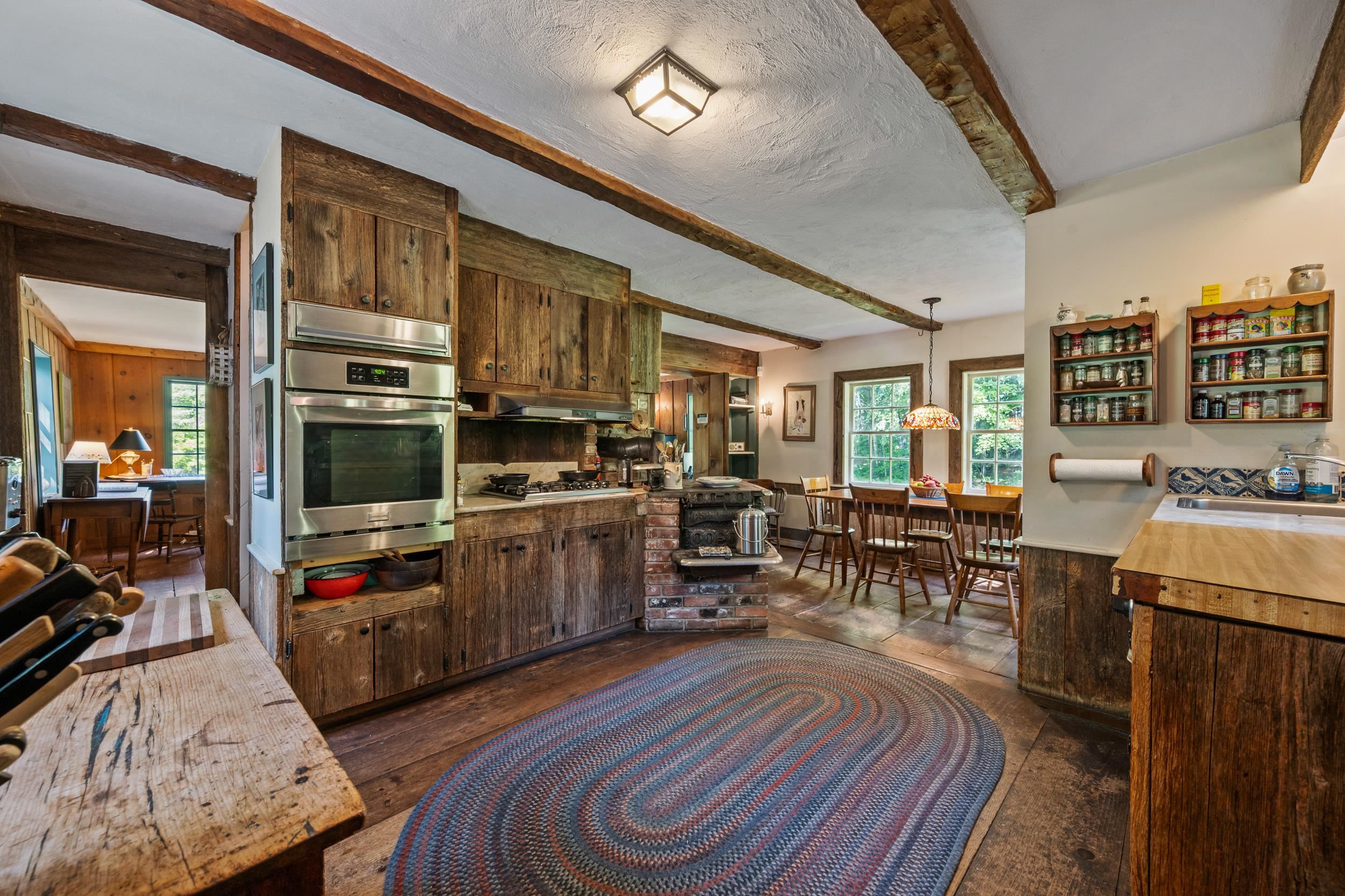 OFF THE LIVING ROOM IS THE SPACIOUS KITCHEN WITH BARN BOARD CABINETRY.