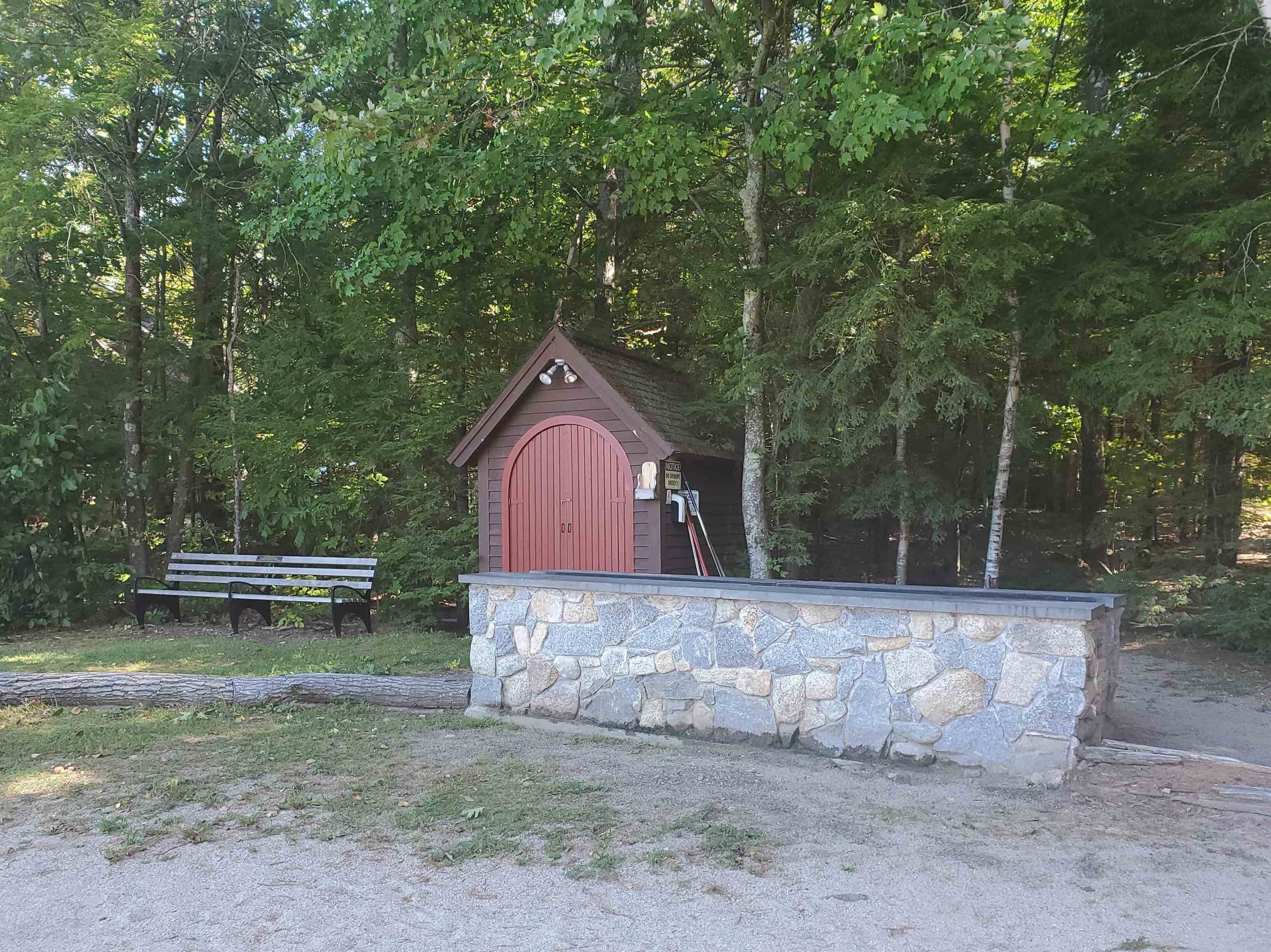 Shared charcoal BBQ next to picnic area