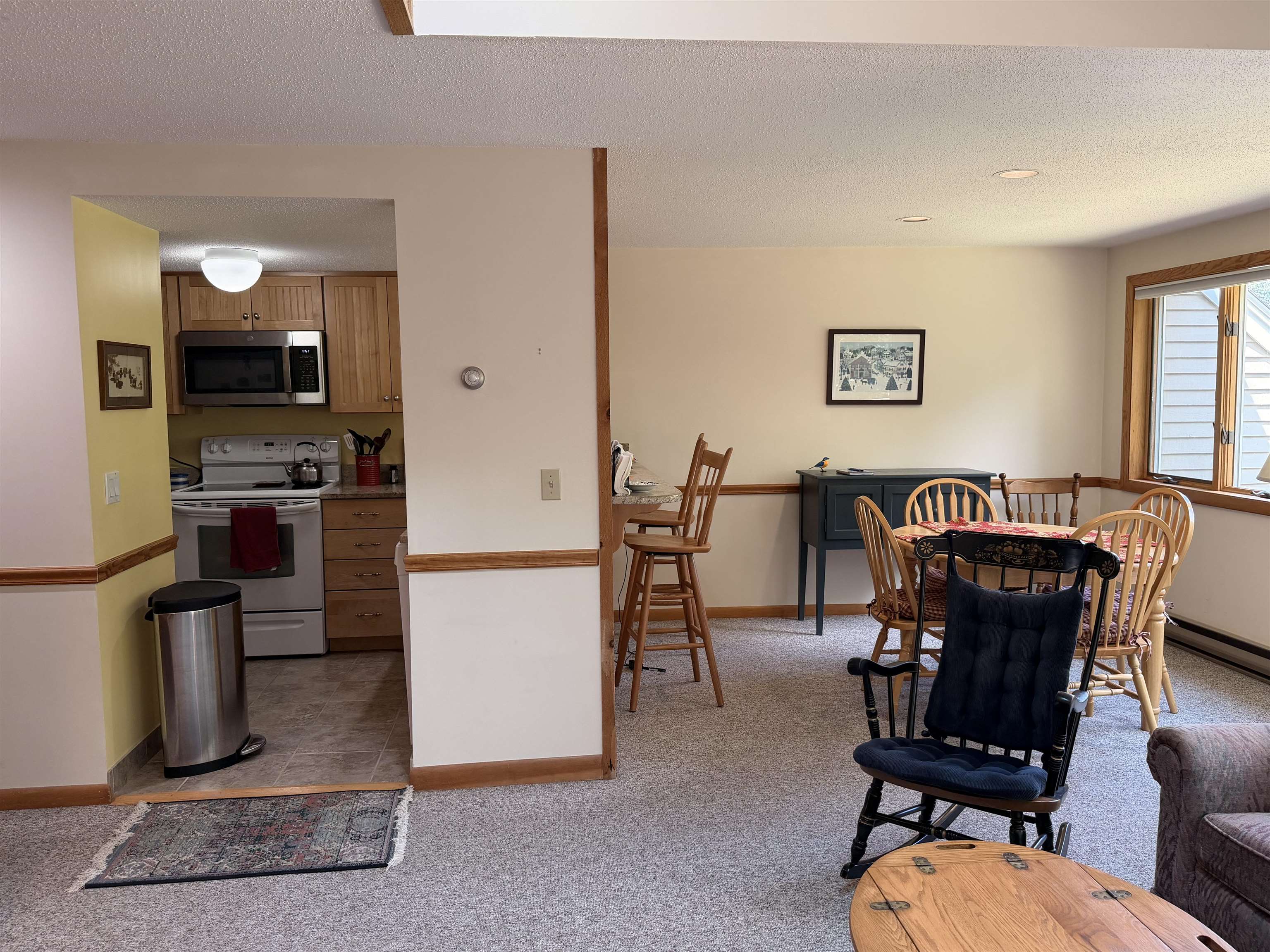 View from far wall, looking towards kitchen and dining