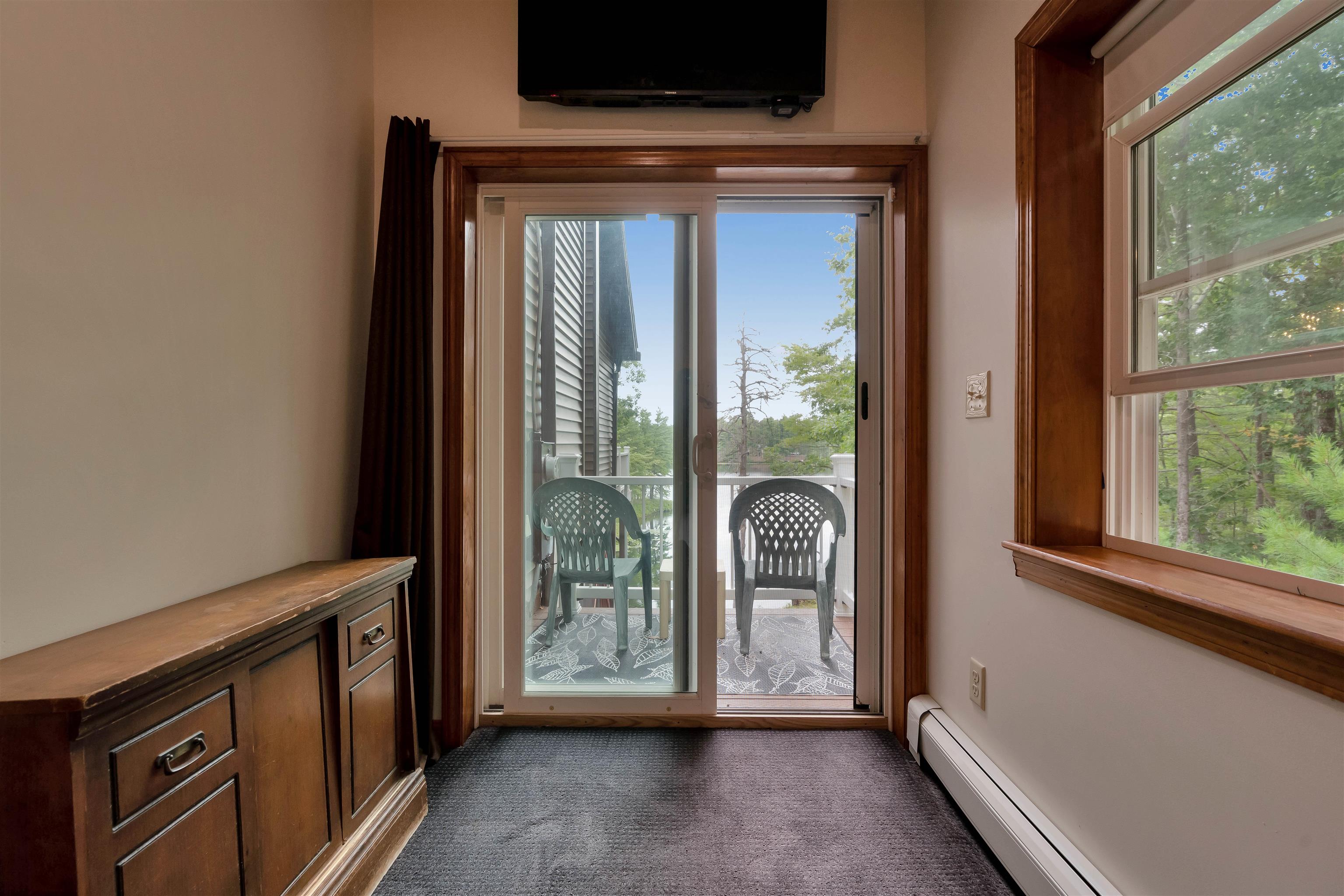 Slider in primary bedroom to private deck overlooking shoreline