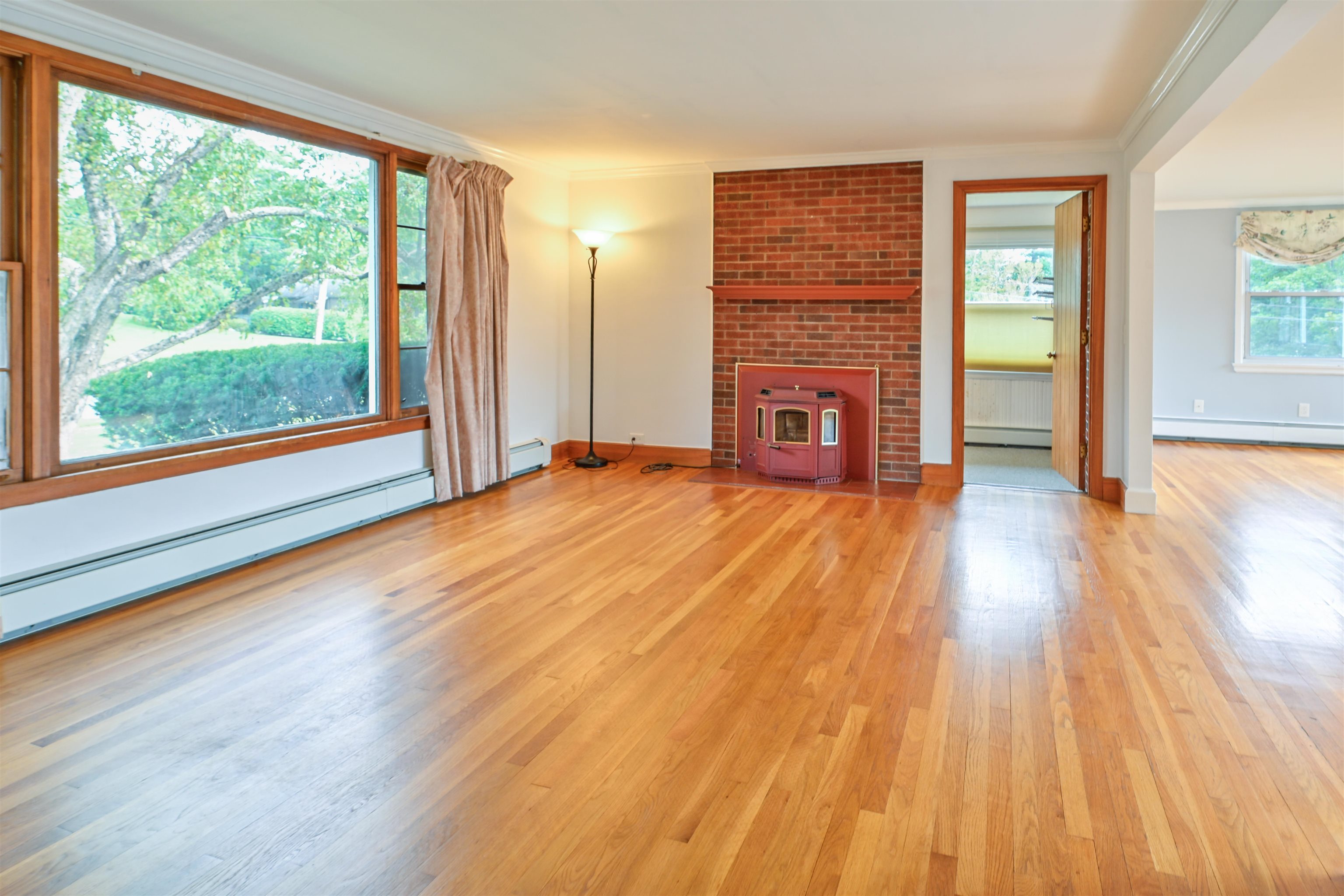 Picture window and pellet stove grace the living room 25924335