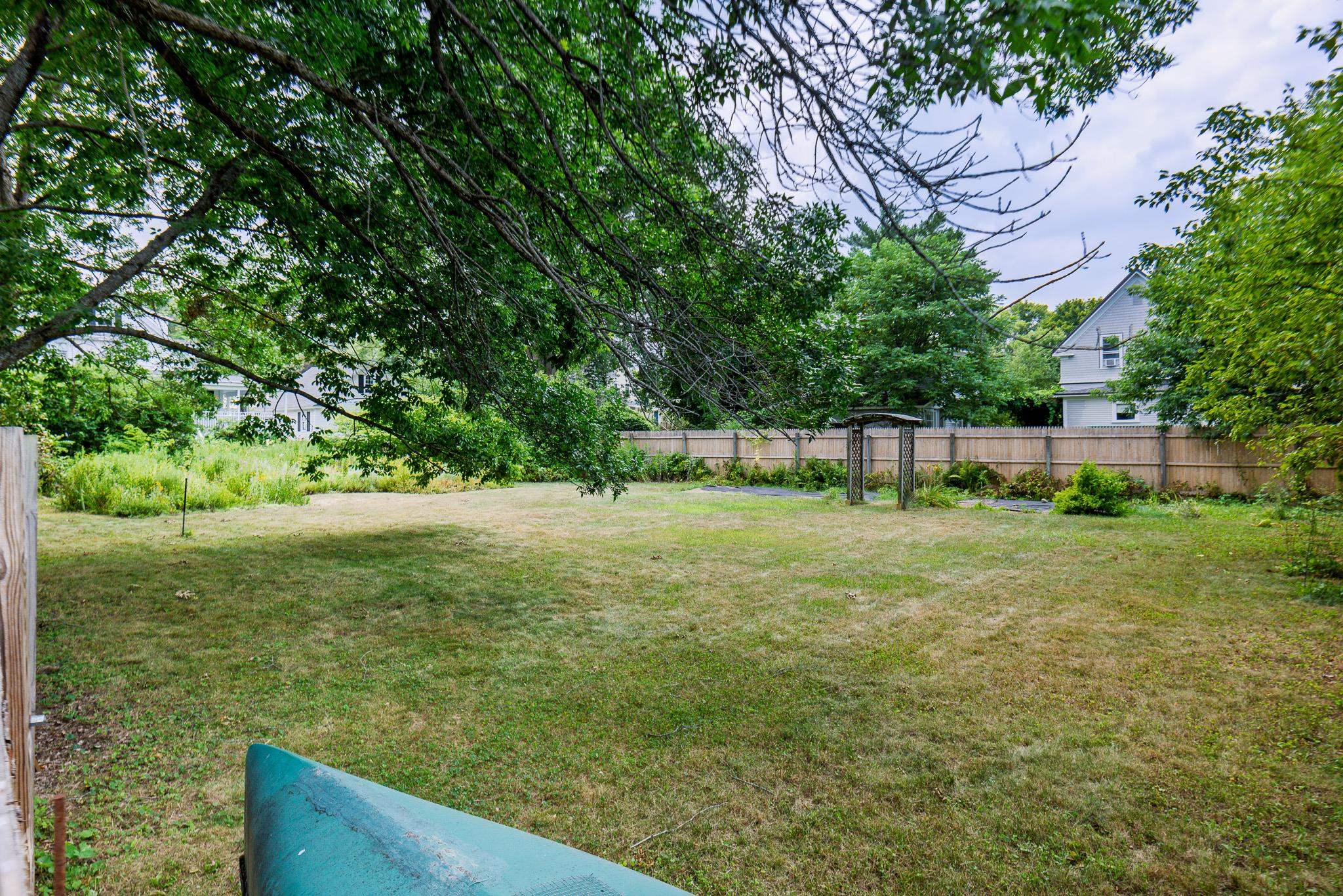 Large fenced-in yard with perennial garden and 3 vegetable plots 25911584