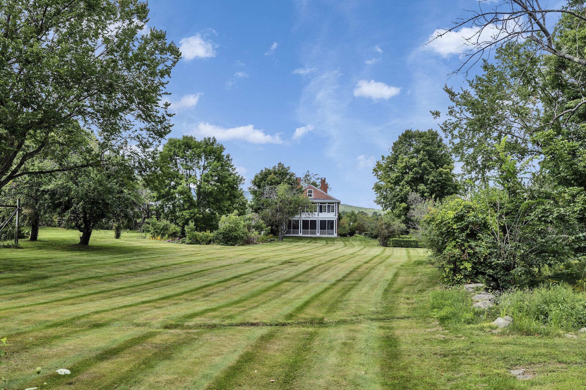 View from side lawn to porches
