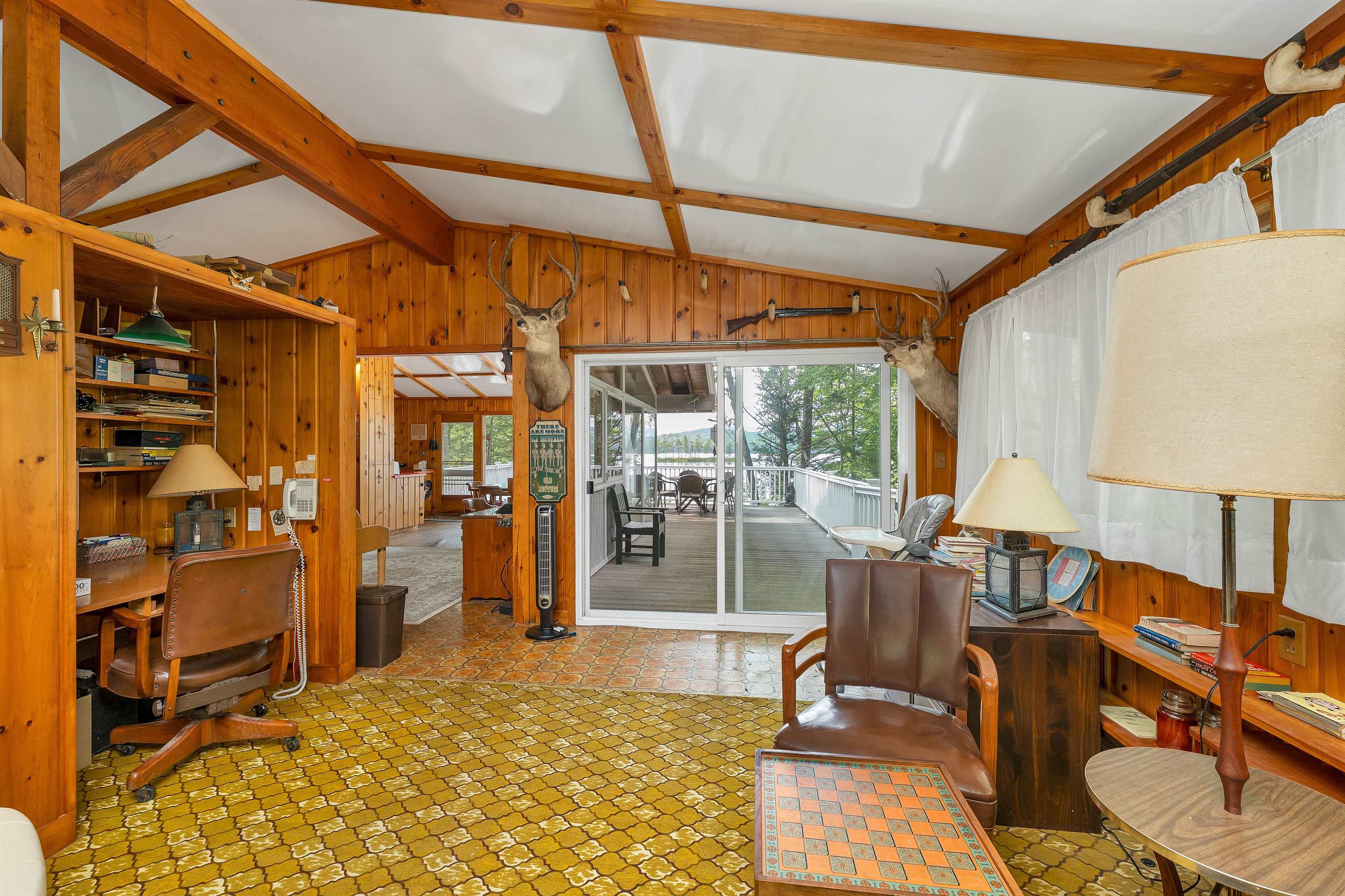 THE CEILINGS ON THE MAIN LEVEL ARE BEAMED AND MATCH THE WOOD WALLS.