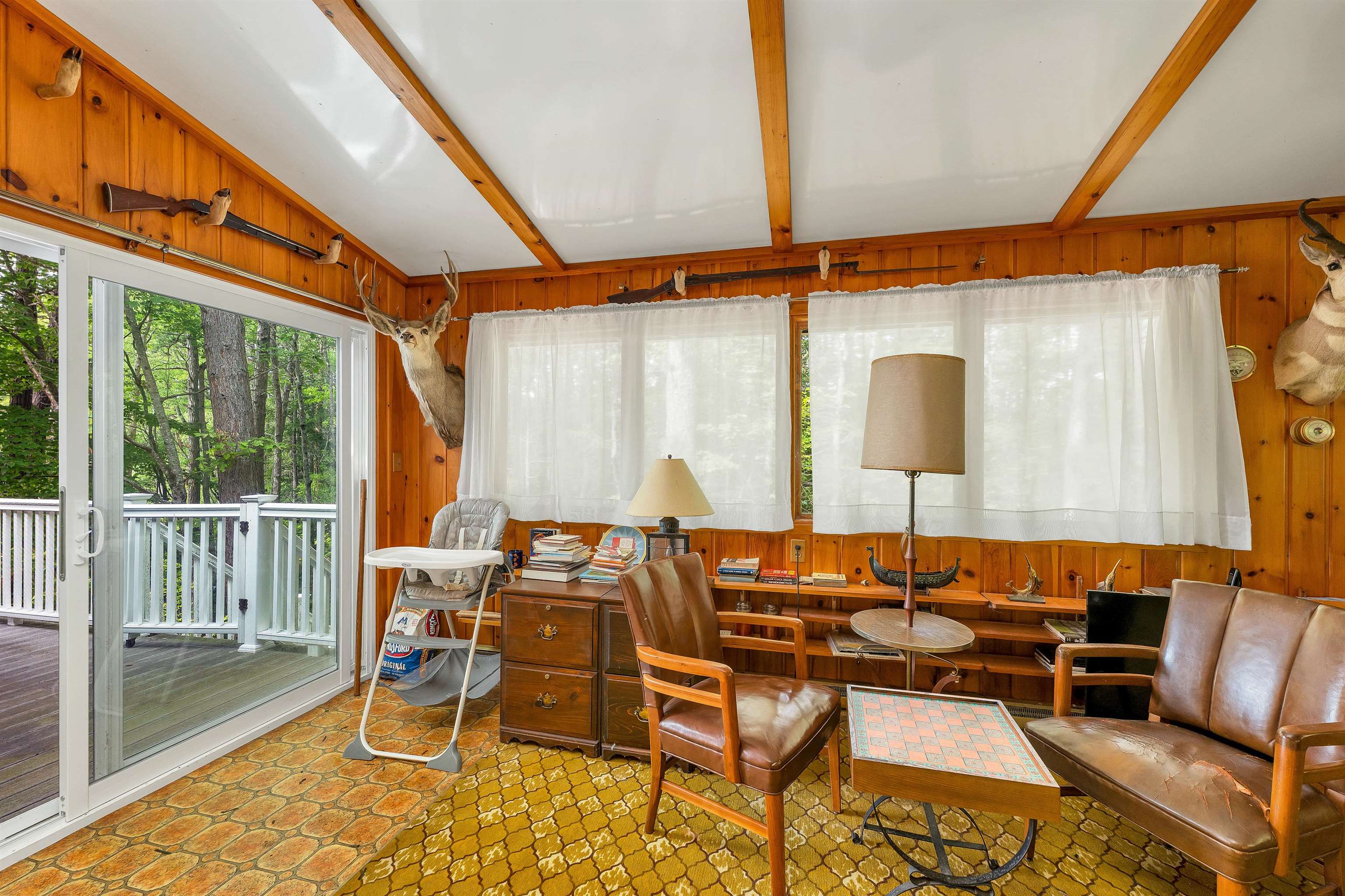 A NEWER SLIDING GLASS DOOR OFFER ACCESS TO THE NEWER COMPOSITE DECK.