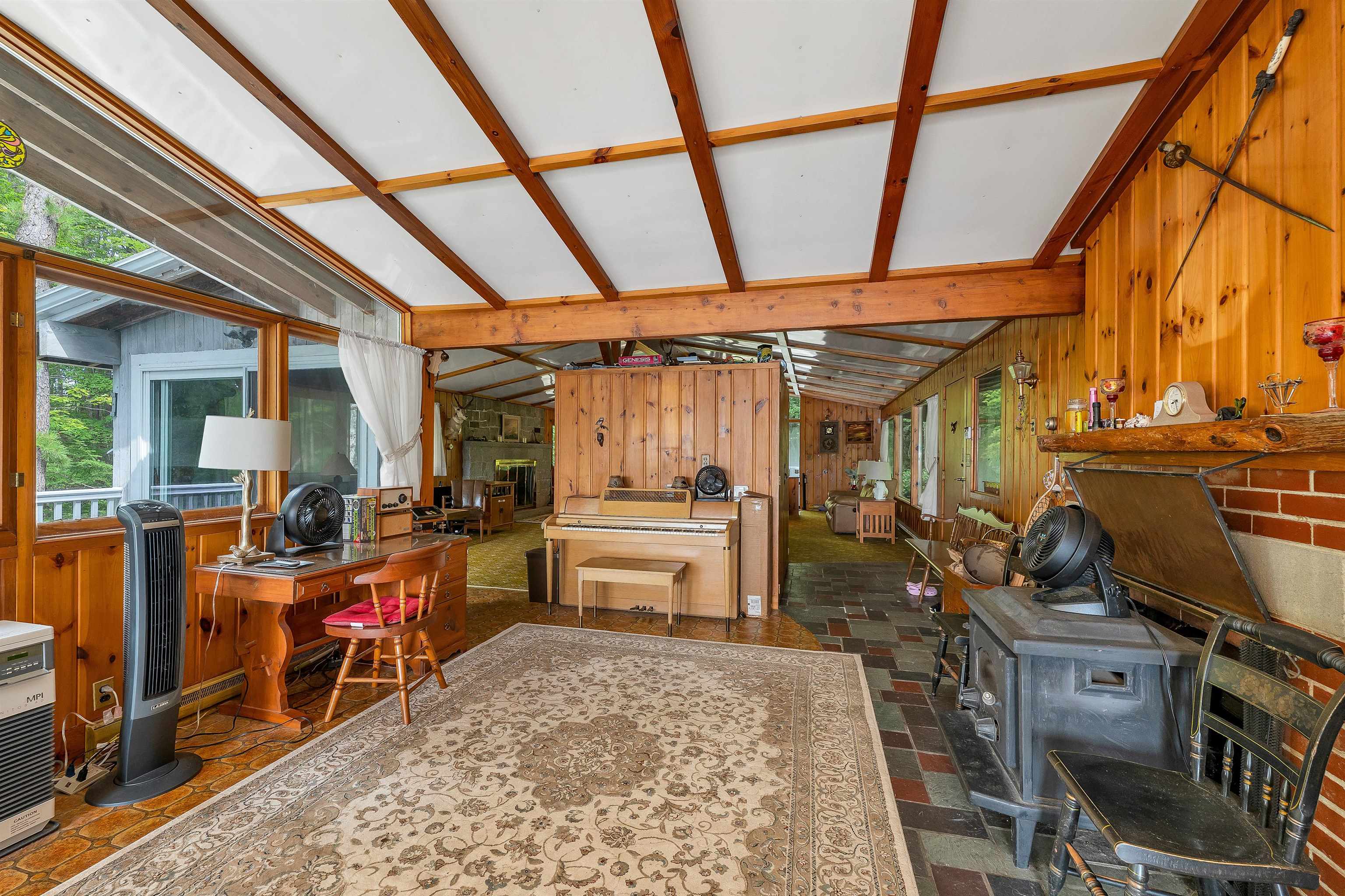 HEADING TOWARDS THE LAKE SIDE OF THE HOUSE IS A SITTING AND MUSIC AREA.