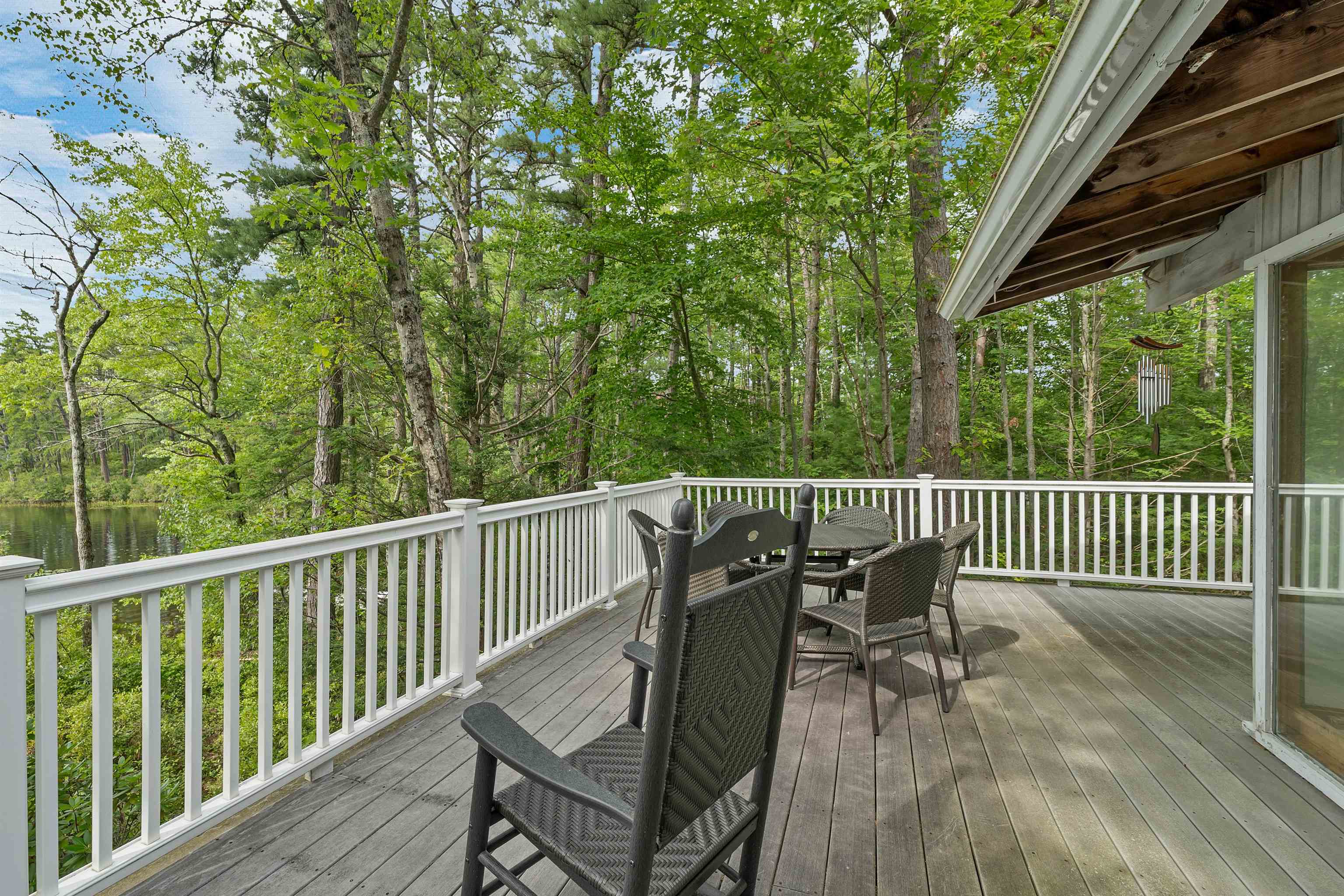 THE WESTERLY DECK LOOKS TO THE AFERNOON SUN,  WATER AND MT. CHOCORUA.  IT IS SO NICE.