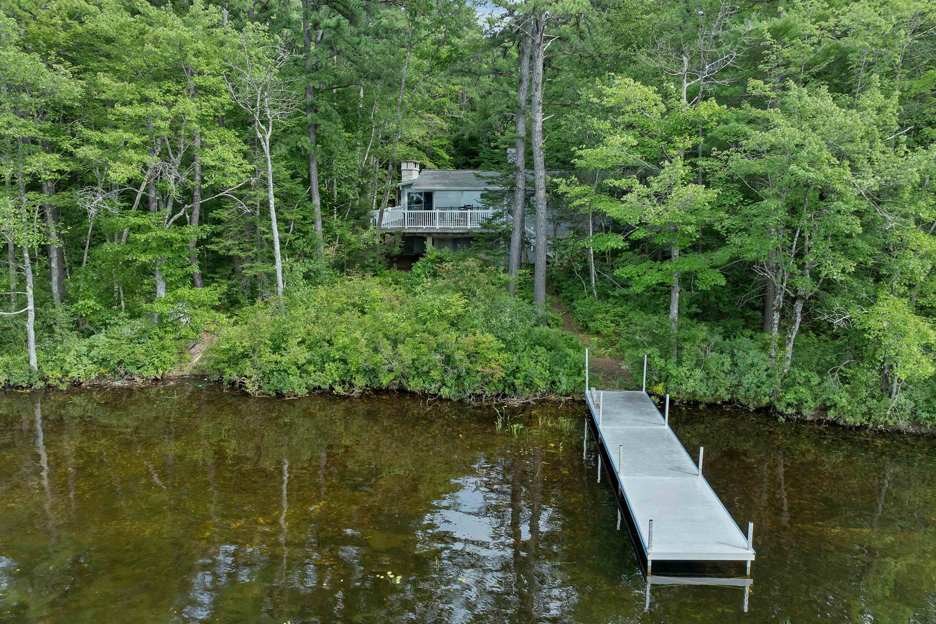 LOOKING FROM THE LAKE DOWN THE DOCK TO THE HOUSE.