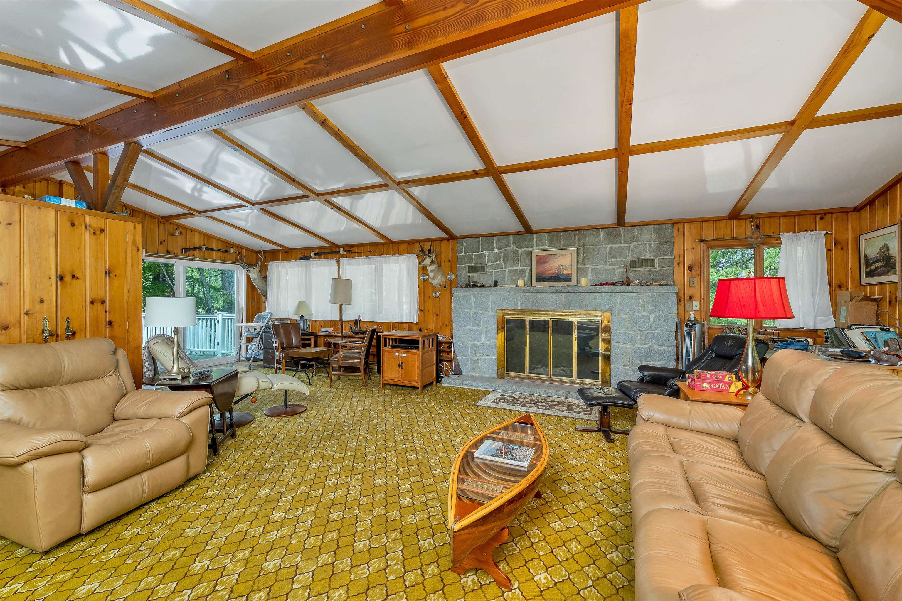 ENTER THE HOUSE INTO AN OPEN LIVING AREA HIGHLIGHTED BY A GRANITE WOOD FIREPLACE.