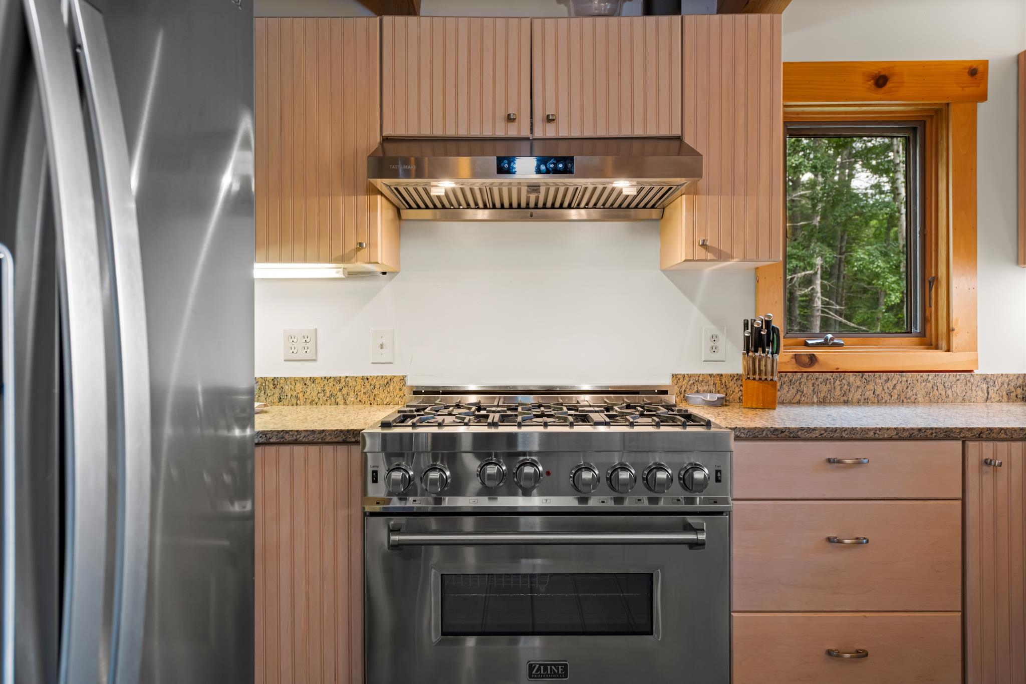 This kitchen features a high end commercial stove