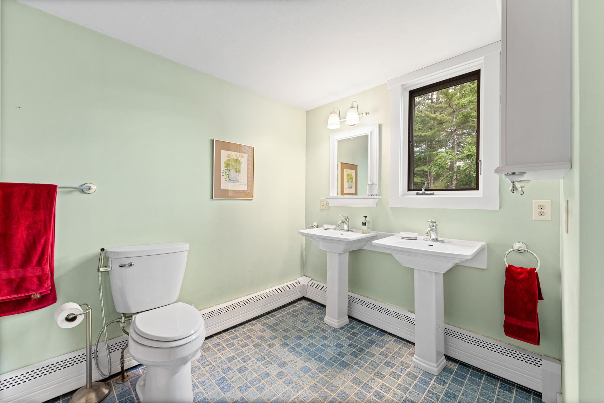 This full bathroom with double vanity and built in cabinets!