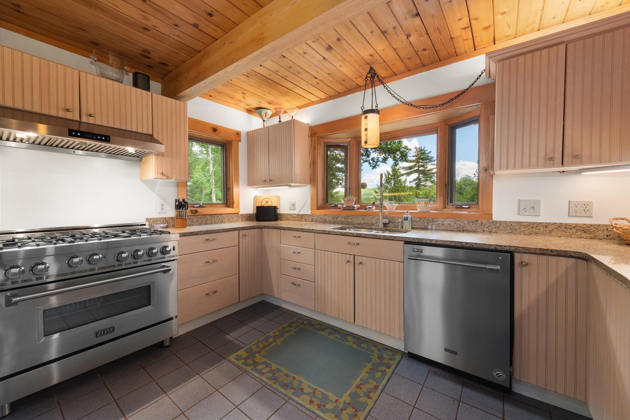 Beautiful cabinets and granite countertops plus a large window overlooking the gardens