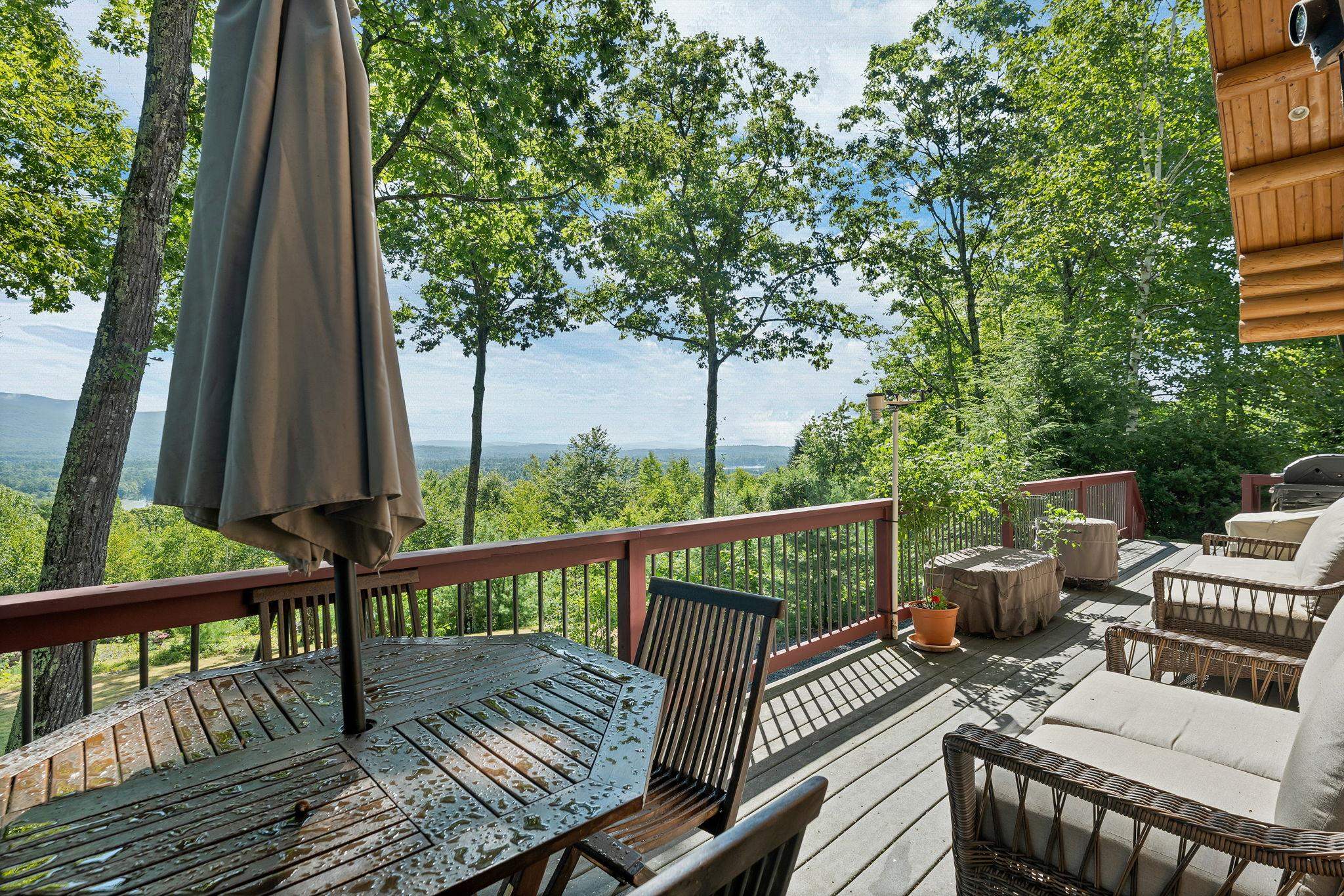 A beautiful deck with umbrella table for you dinning with a view