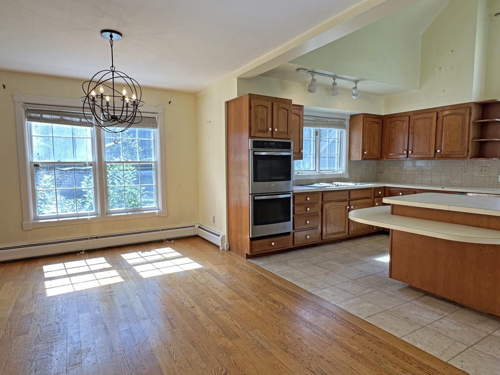 Dining Room with Wood Floors and Spacious Kitchen with Tiles 26056467