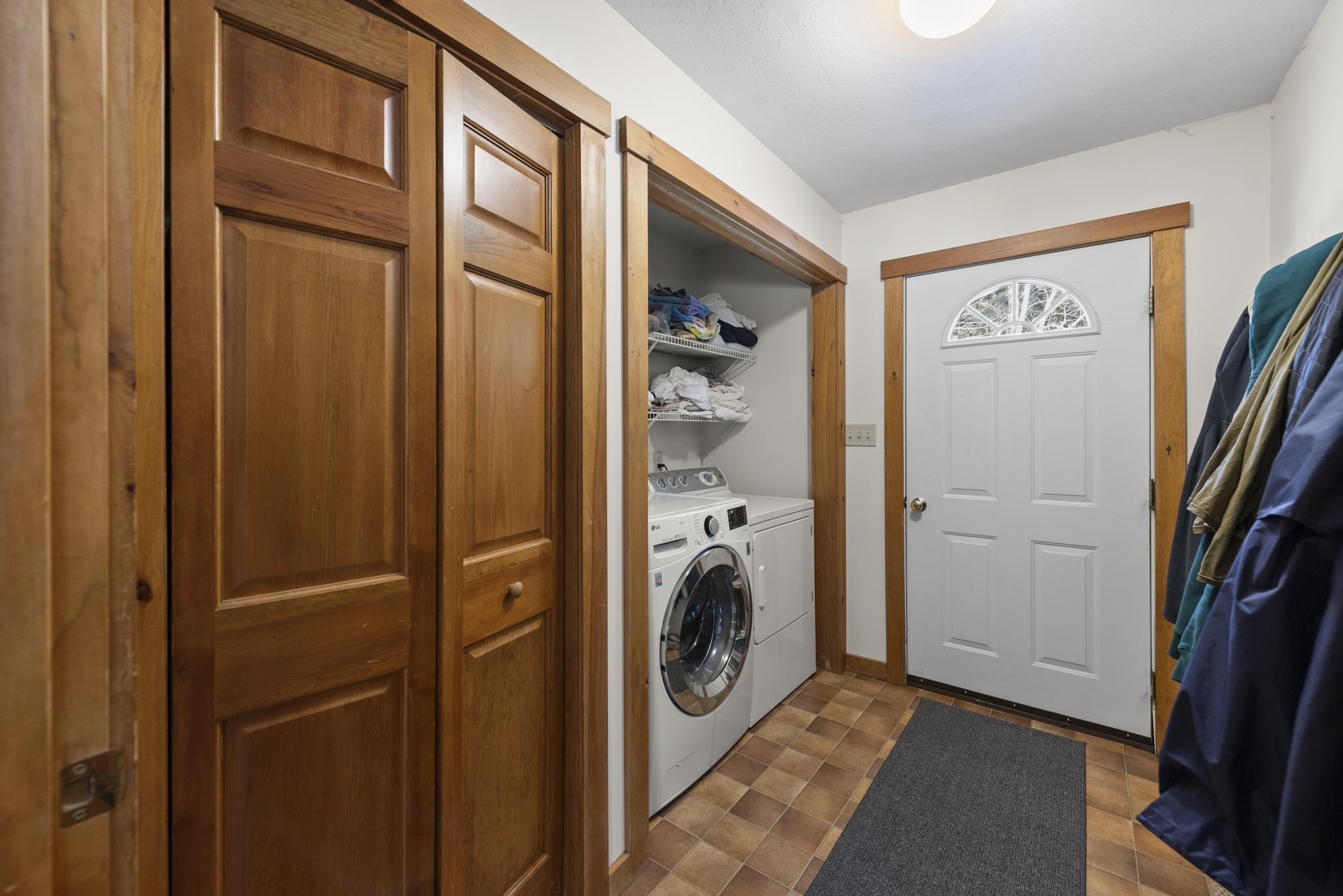 The laundry room is set with off the kitchen with a door that opens up to the backyard