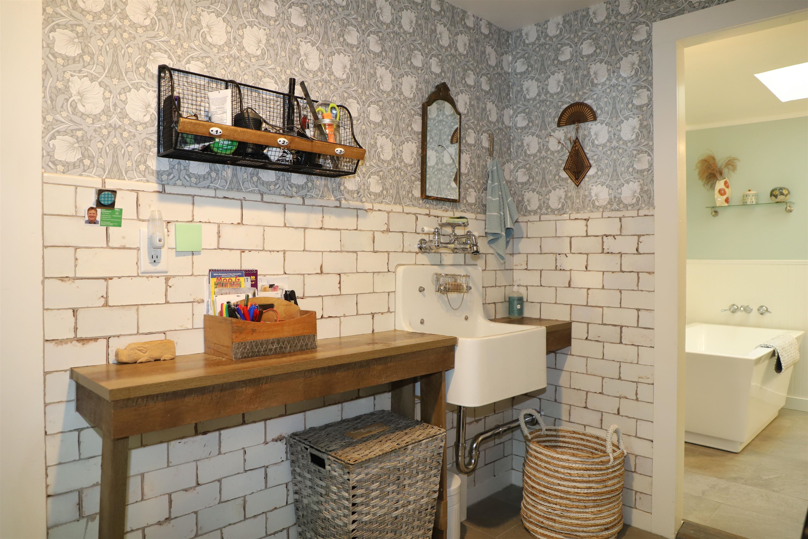 Laundry sink with custom tiled wall.