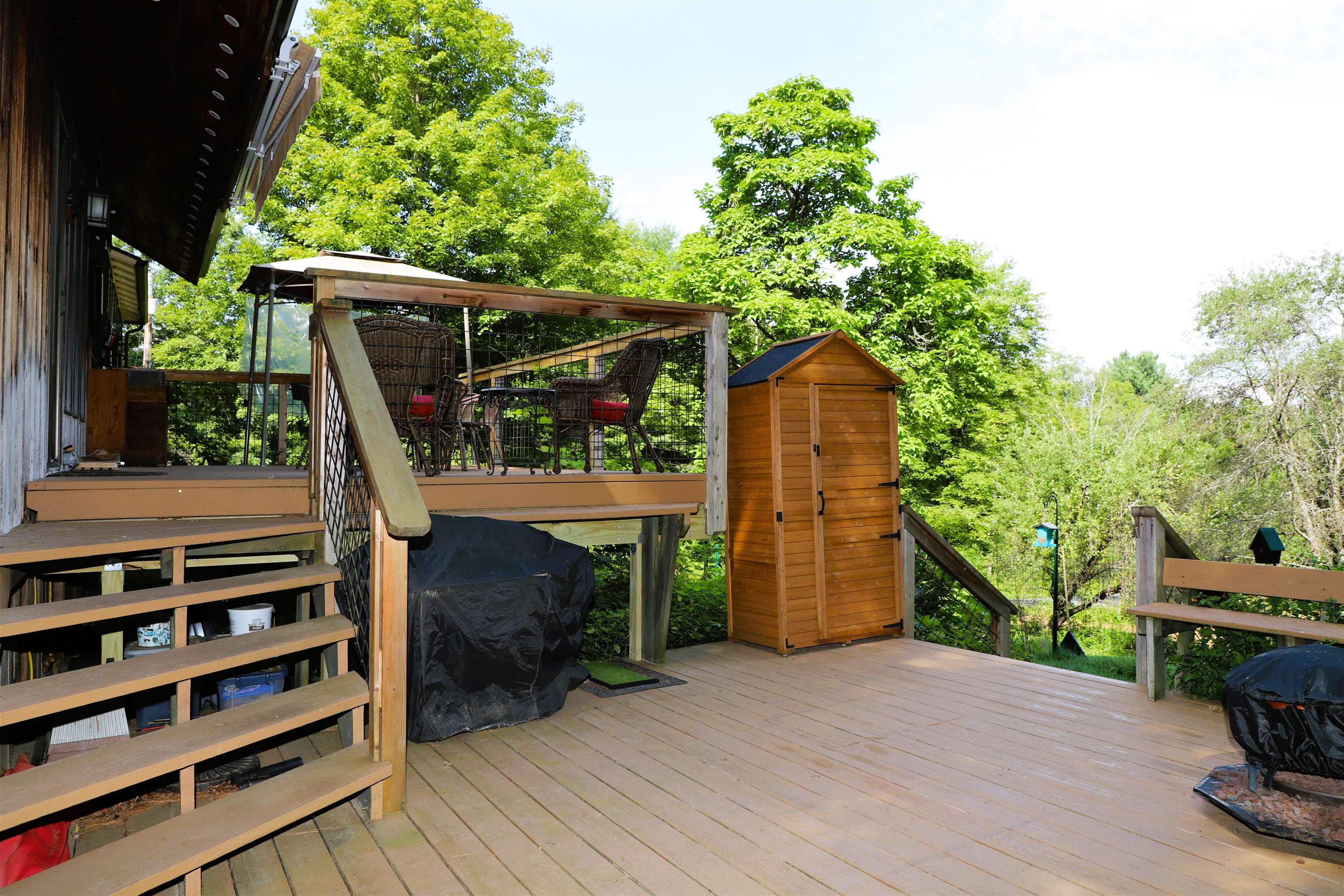 Lower deck enters into the side yard and meadow