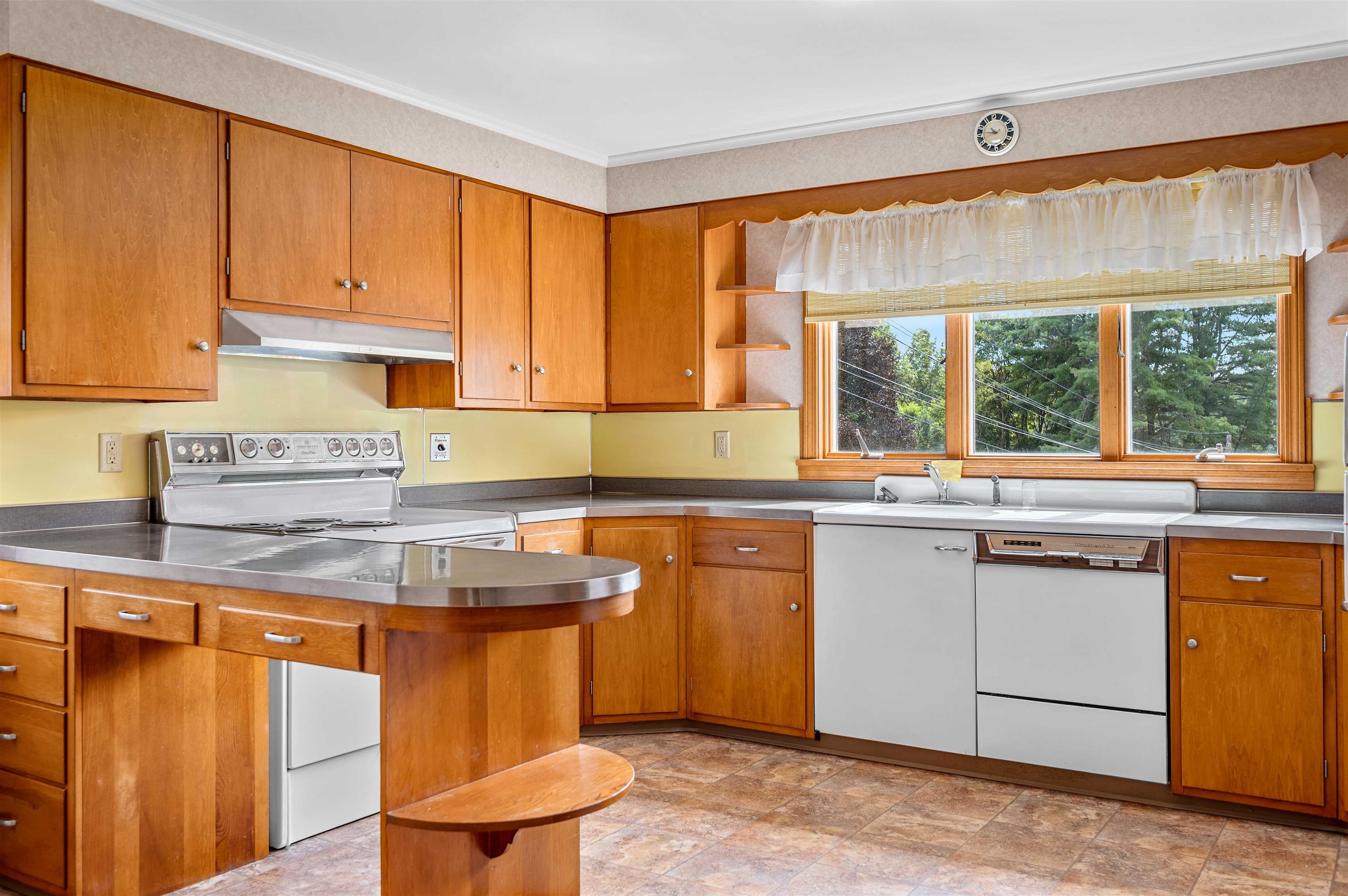 Open bright kitchen with bar