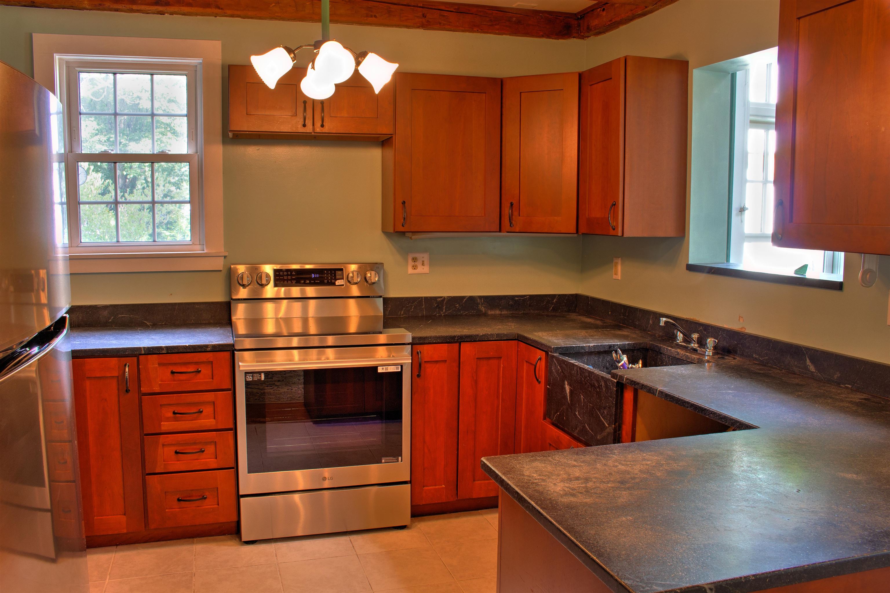 Comfortable Kitchen With Soap Stone Counters and New Appliances