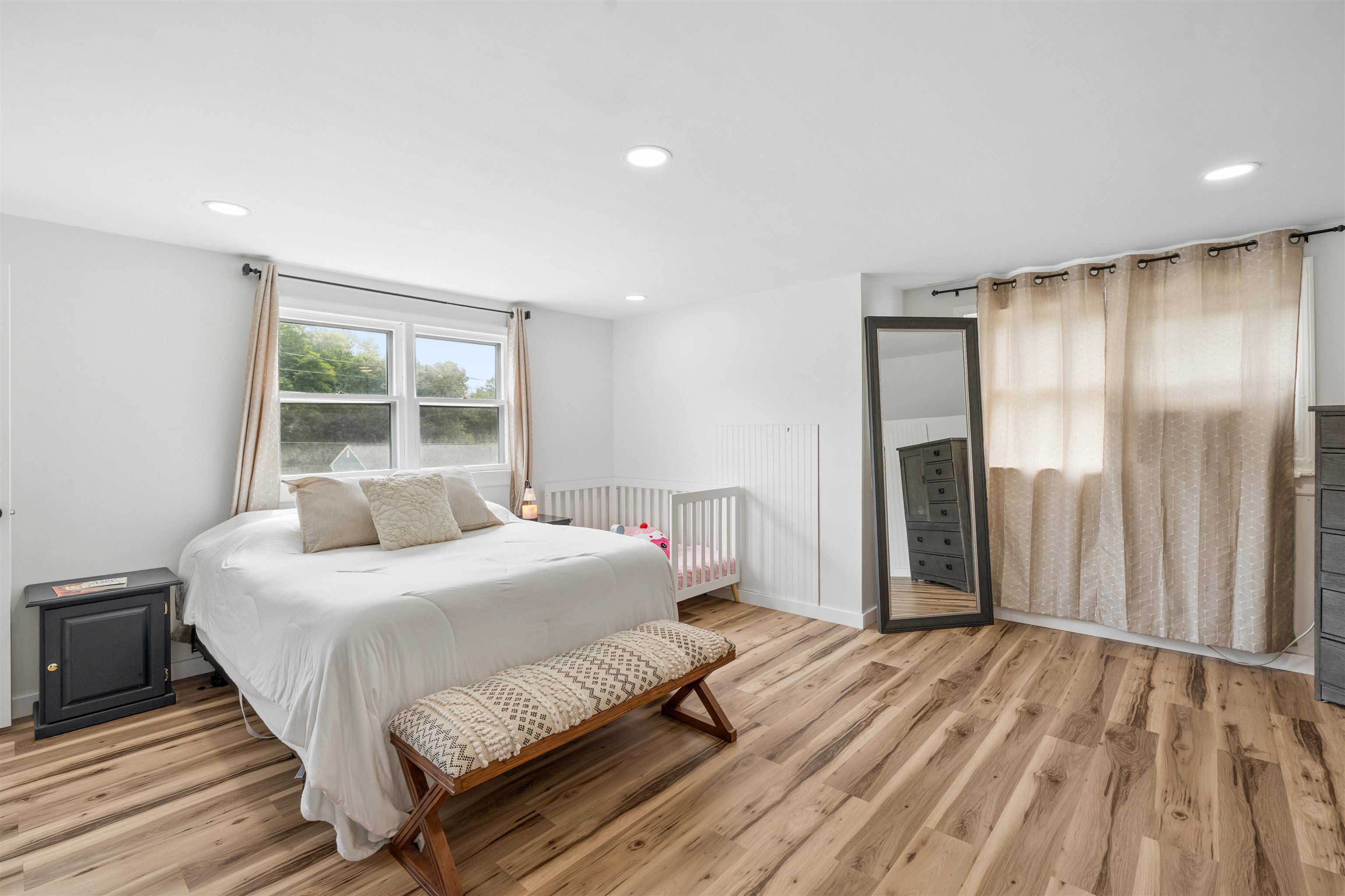Primary bedroom with a half bath