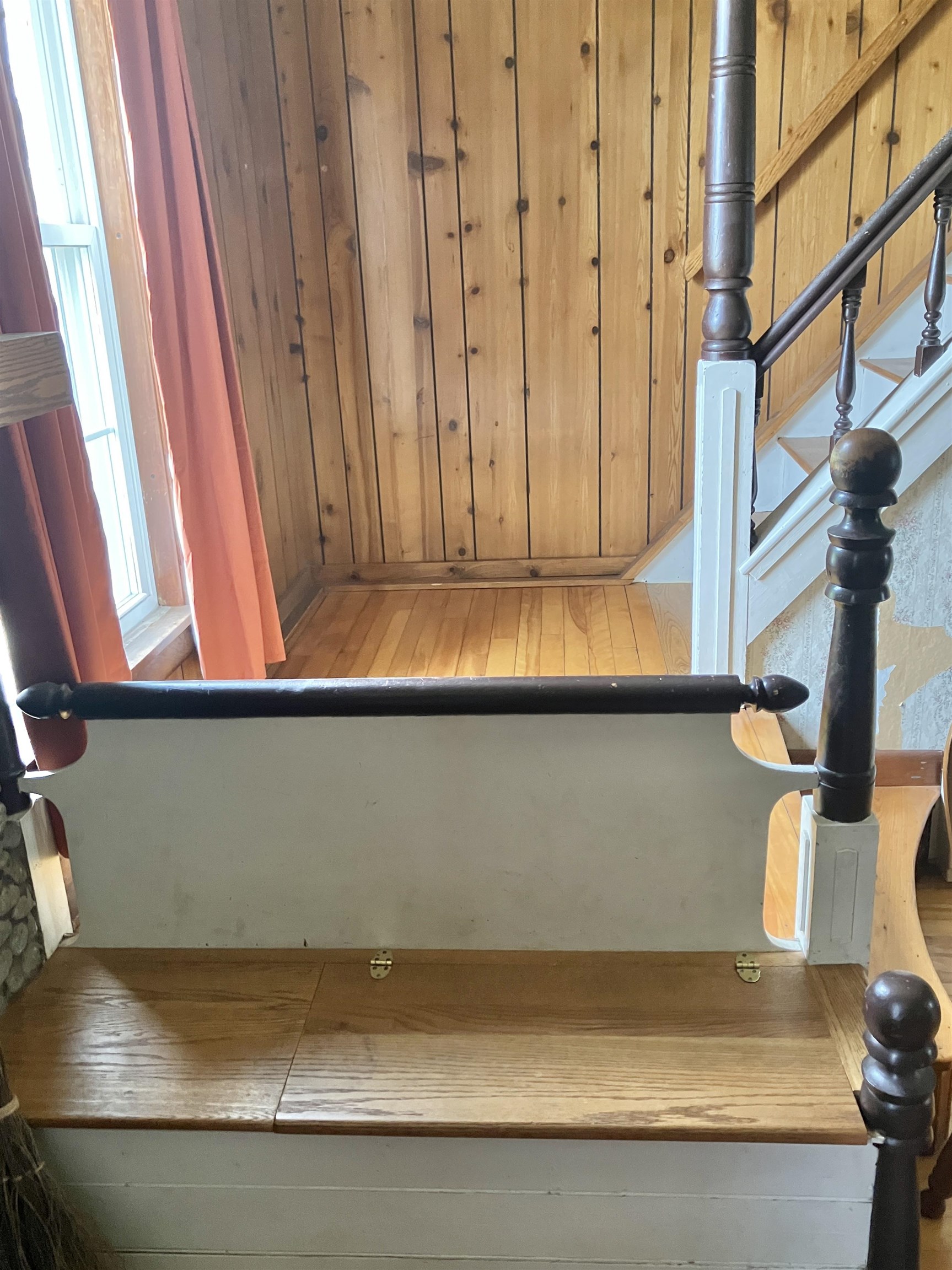 Built-in fireplace storage bench for kindling and paper.... matches the stair banister!