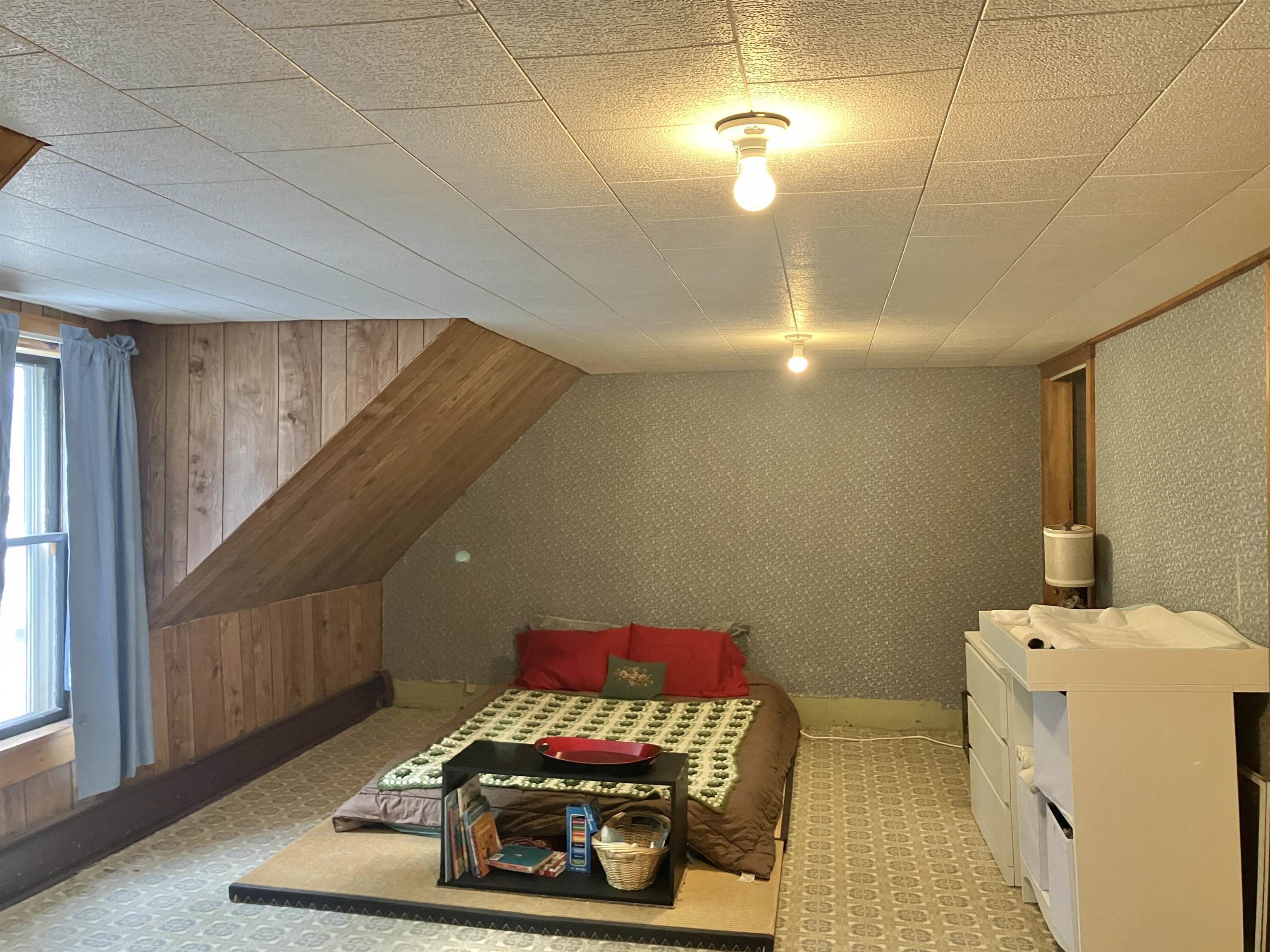Spacious primary bedroom is off the living room stairway