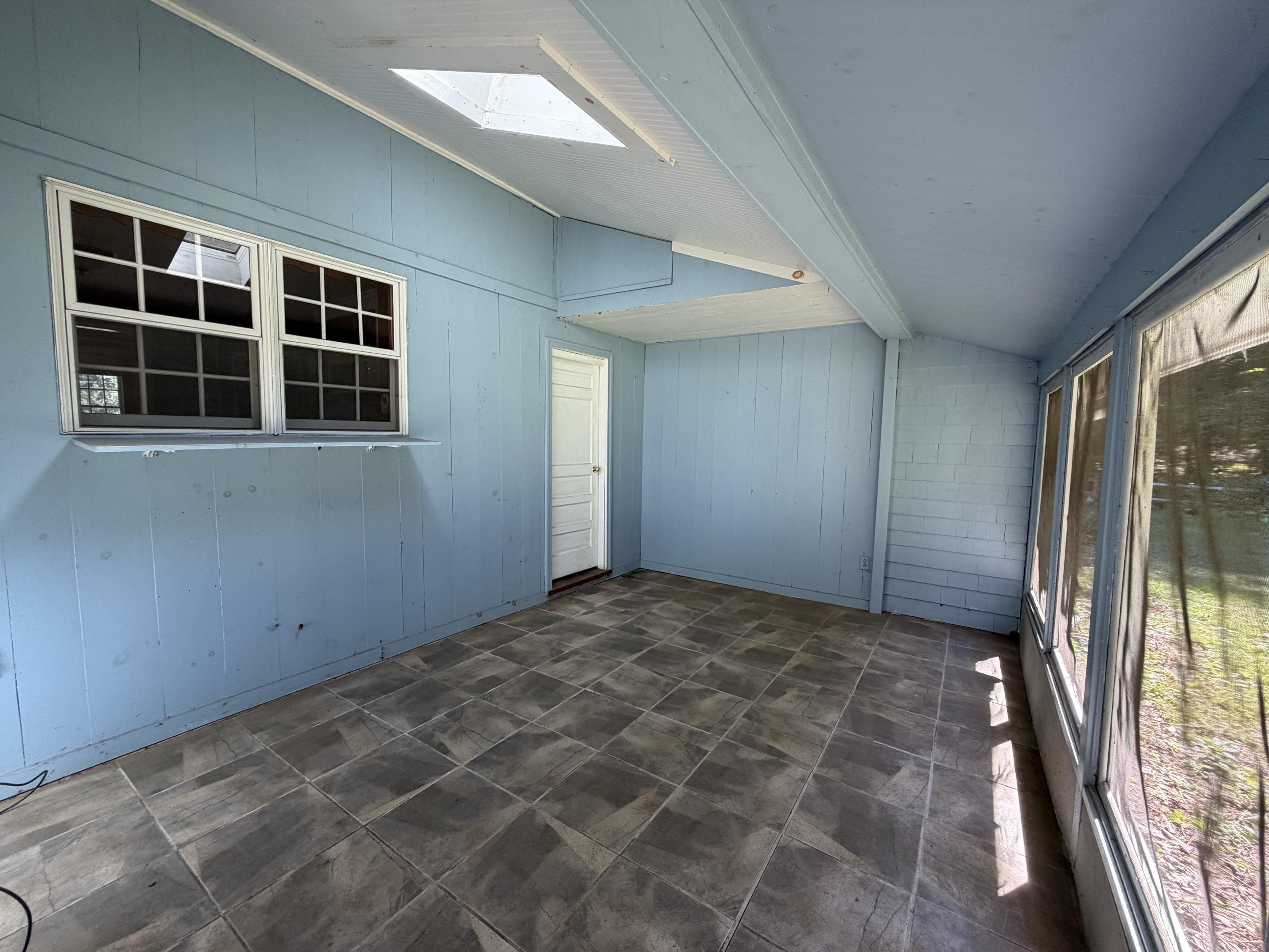 enclosed porch attached to garage overlooking backyard