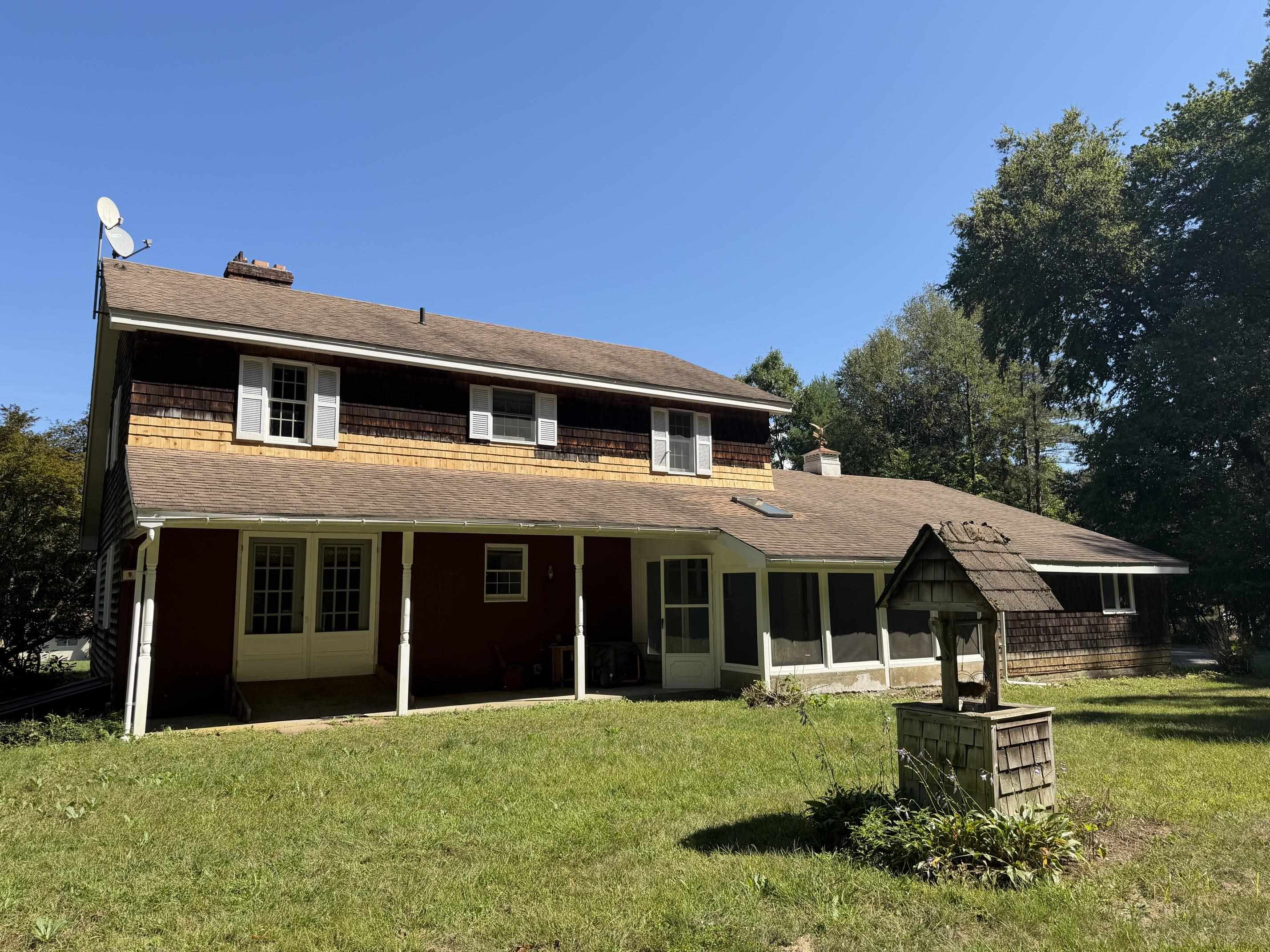Back of house- covered porch access to den and enclosed porch