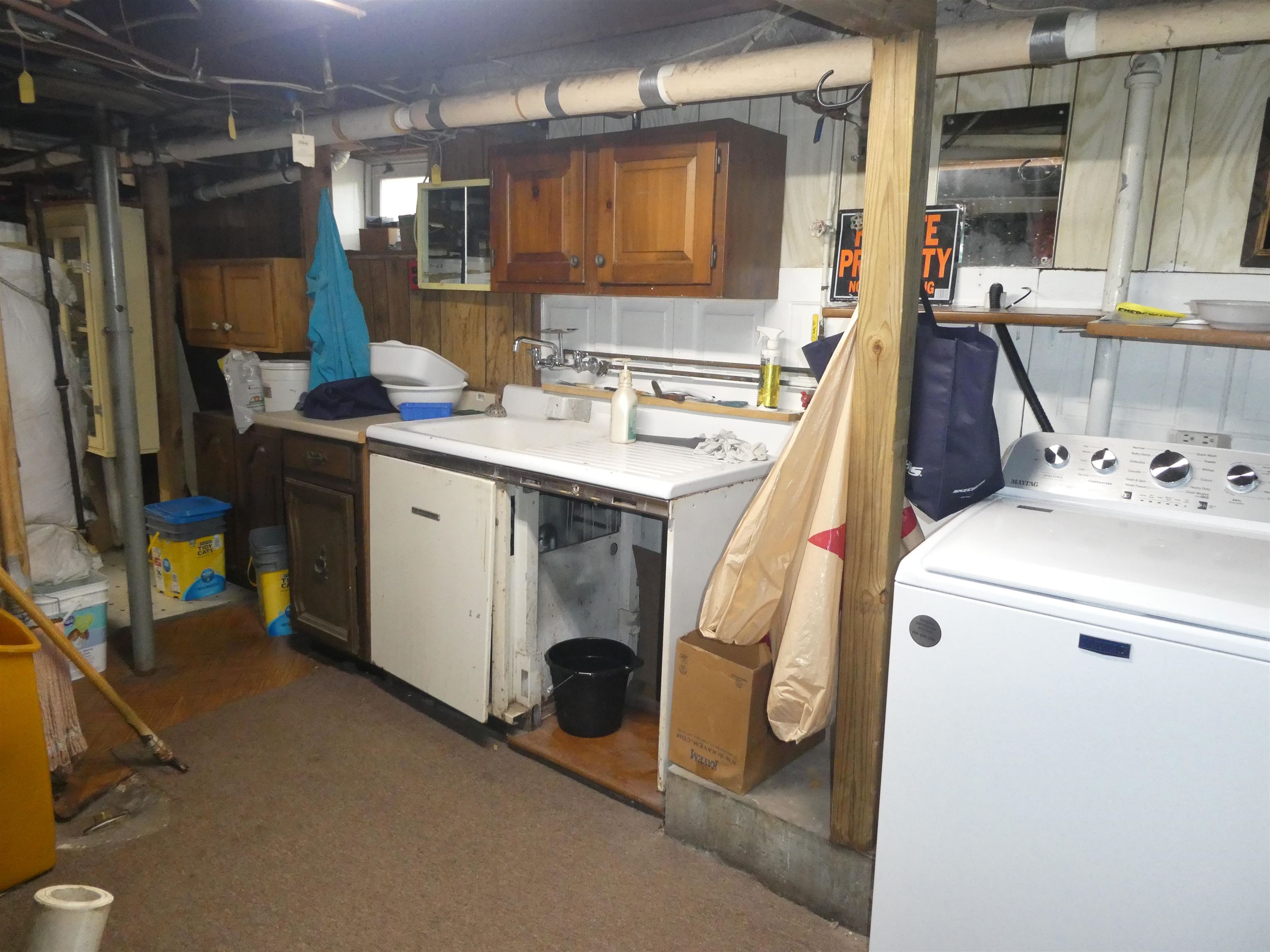 WASHER AND DRYER WITH STORAGE CABINETS IN BASEMENT