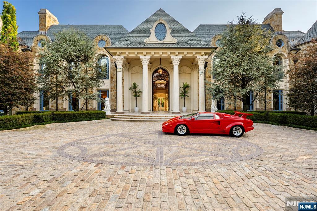 In Alpine's most coveted enclave, where prestige meets perfection, 31 Rio Vista Drive rises as a rare statement of architectural artistry and uncompromising luxury. Set on two manicured acres behind stately gates, this 2017-built estate spans nearly 21,000 sq ft and commands attention with a dramatic bridge marble staircase, custom wood floors, and heated marble underfoot. From the private elevator connecting the basement to the roof deck, to the state-of-the-art custom kitchen, every element is meticulously crafted. Venetian plaster walls add timeless texture, while nine fireplaces, custom closets, and spa-inspired baths offer unmatched comfort. More than nine A/C units and solar panels ensure modern efficiency without sacrificing elegance.
