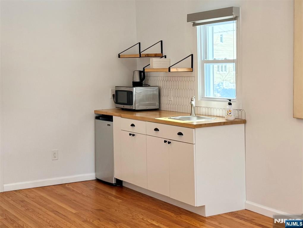 Coffee area in main room with mini refrigerator and microwave