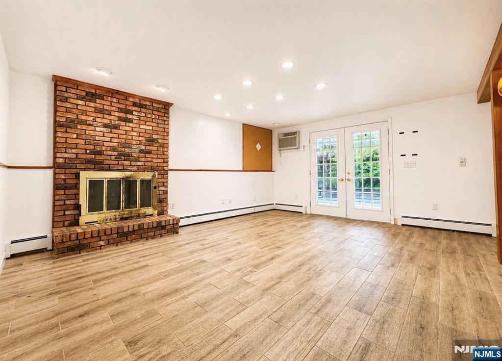 LOWER LEVEL LIVING AREA FRENCH DOORS TO 3 SEASON PORCH