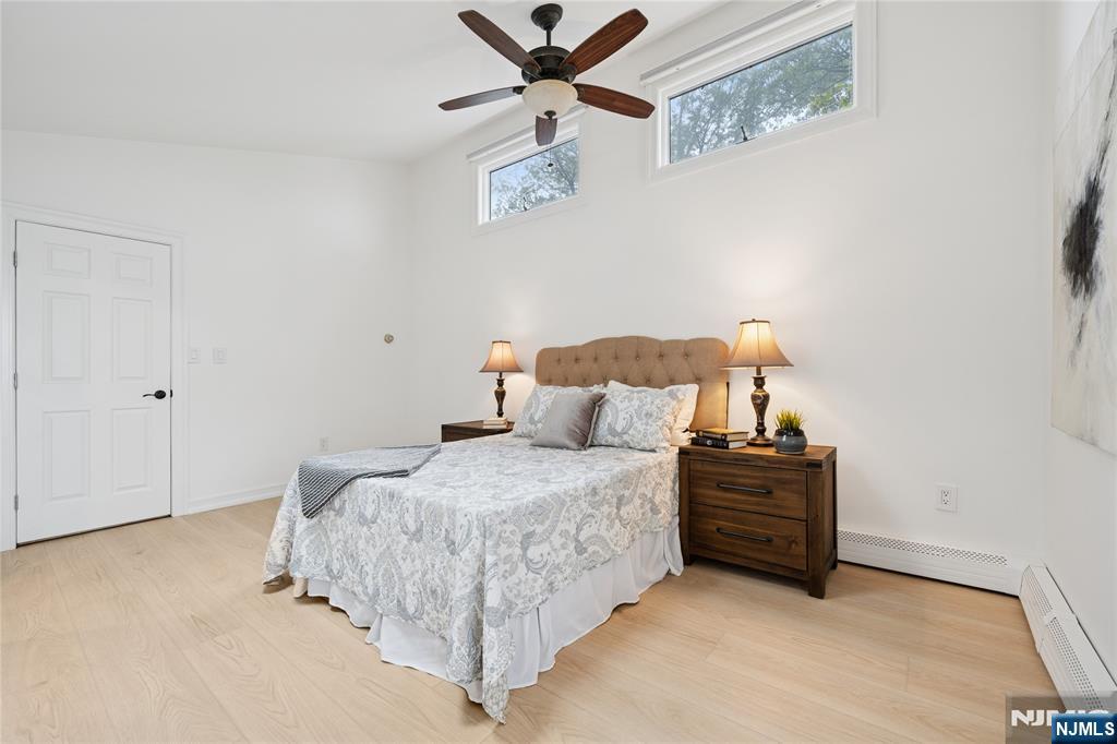 Primary Bedroom with vaulted ceiling and skylight