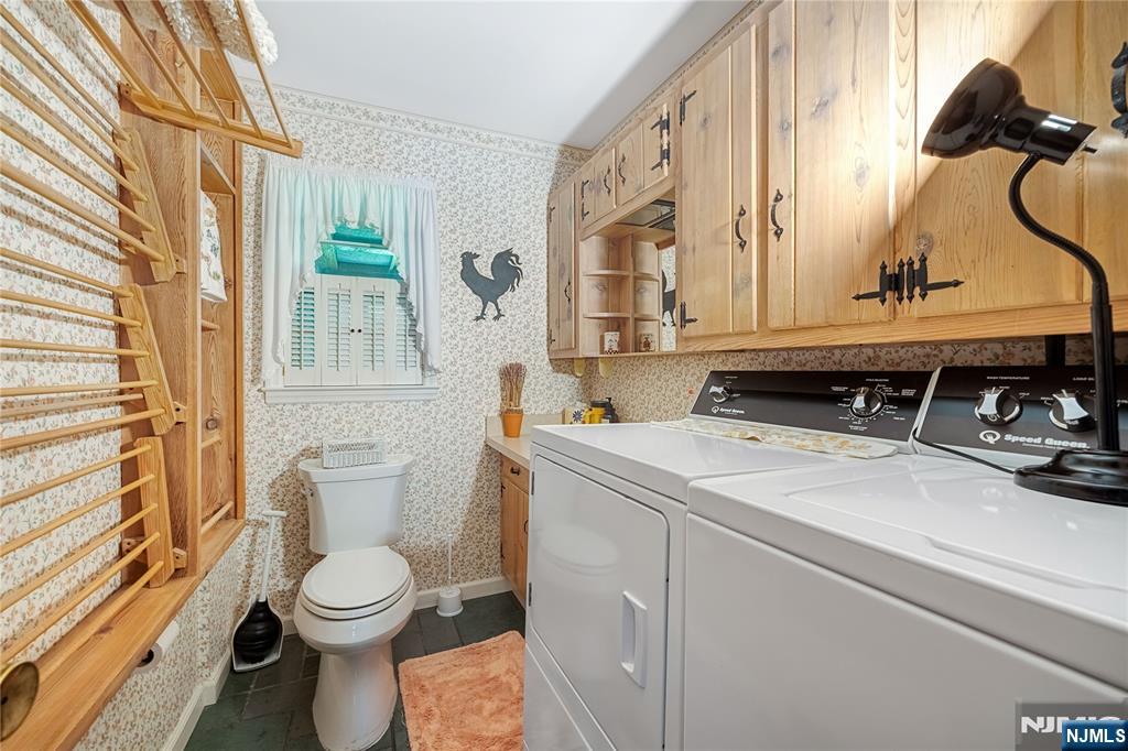Half bath with washer and dryer and drying racks