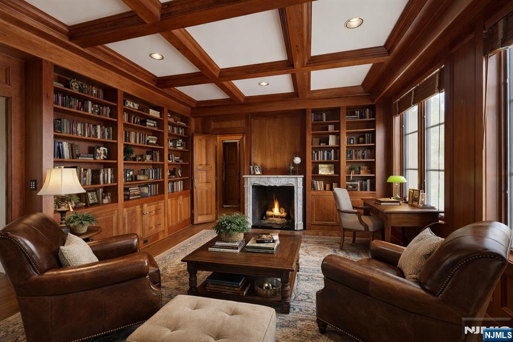 Library with fireplace , virtually staged.