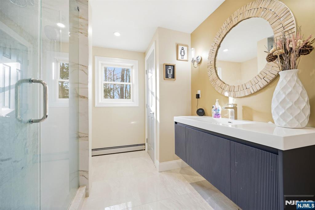 full bath with floating vanity